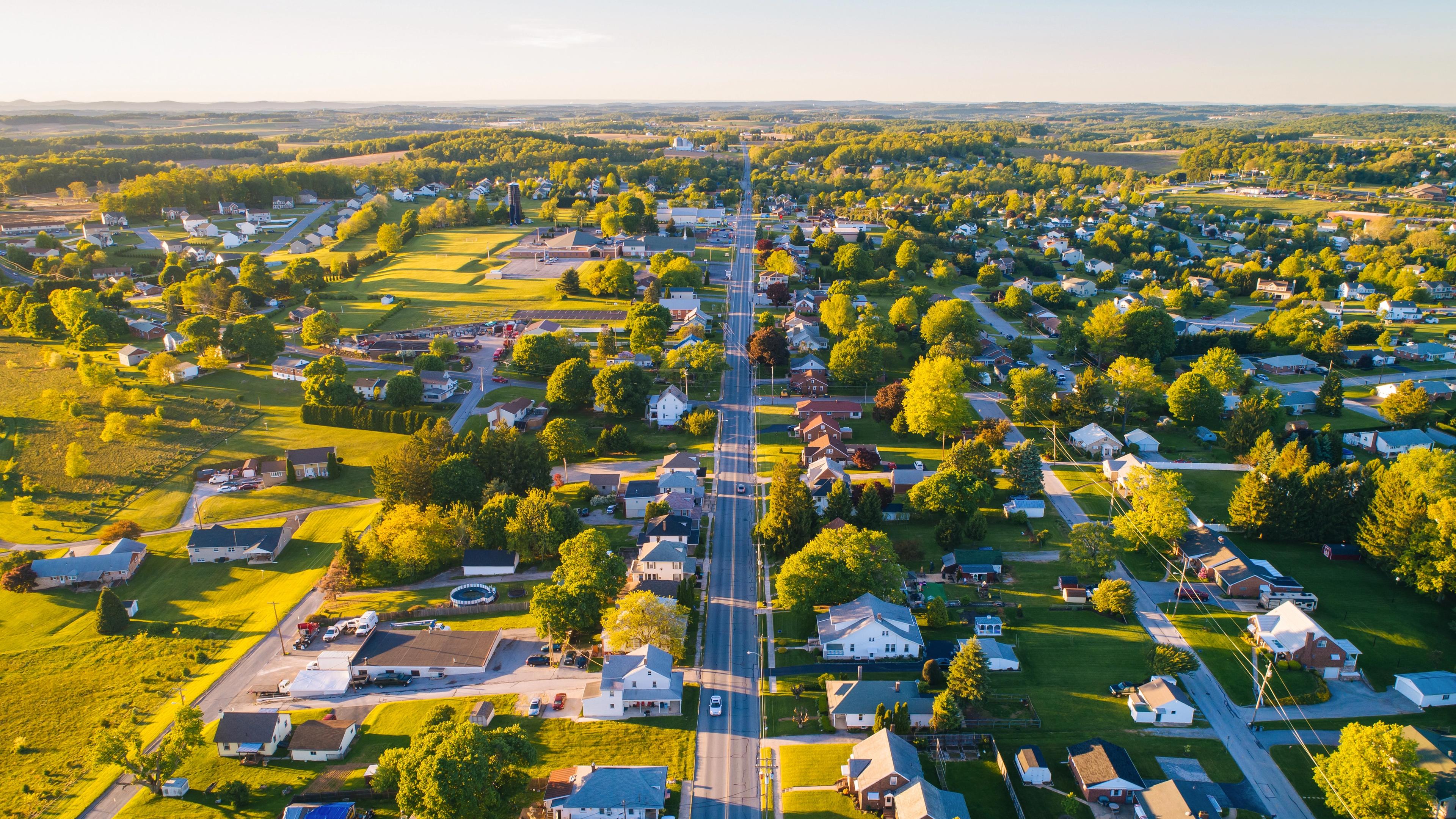 Aerial view of Mooresville Station neighborhood in Tanner Alabama with tree-lined streets homes and green fields