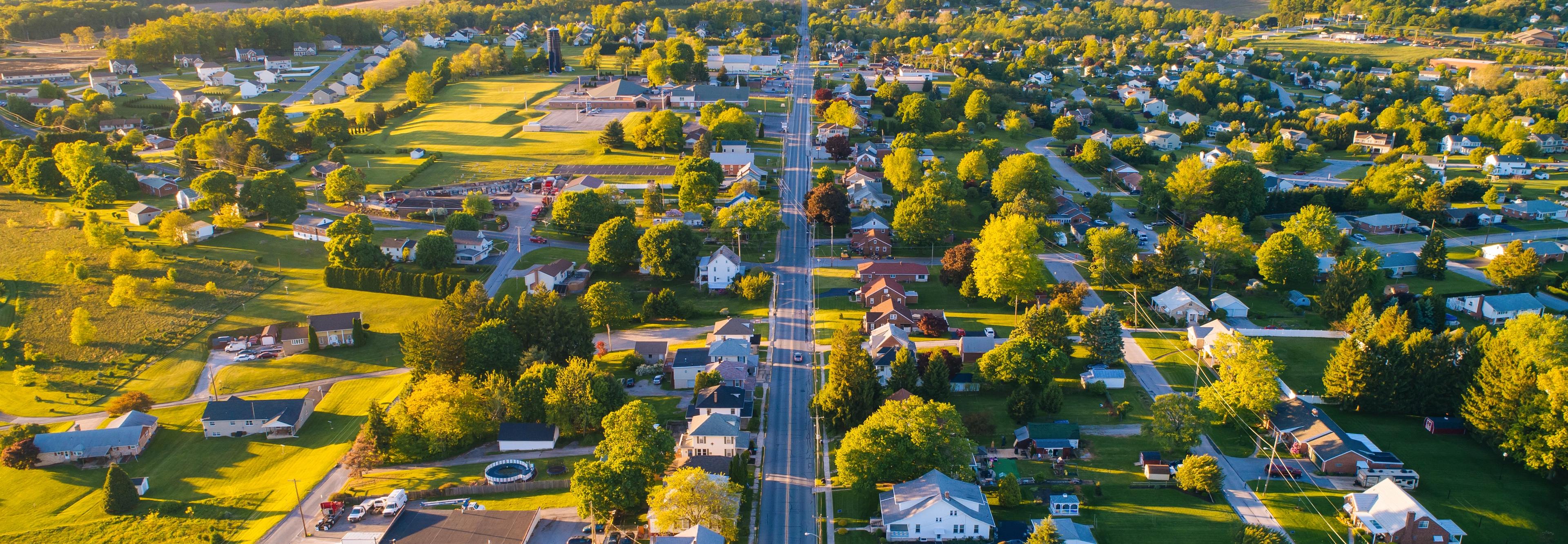 Aerial view of Mooresville Station neighborhood in Tanner Alabama with tree-lined streets homes and green fields