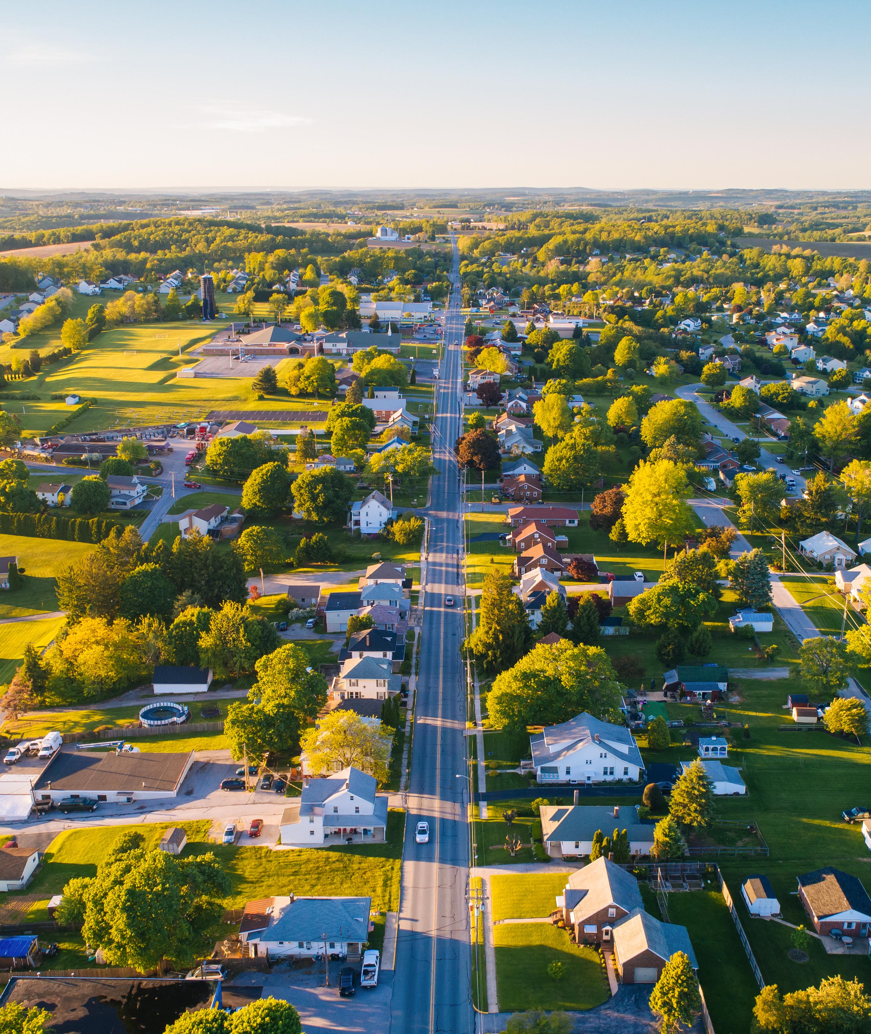 Aerial view of Mooresville Station neighborhood in Tanner Alabama with tree-lined streets homes and green fields