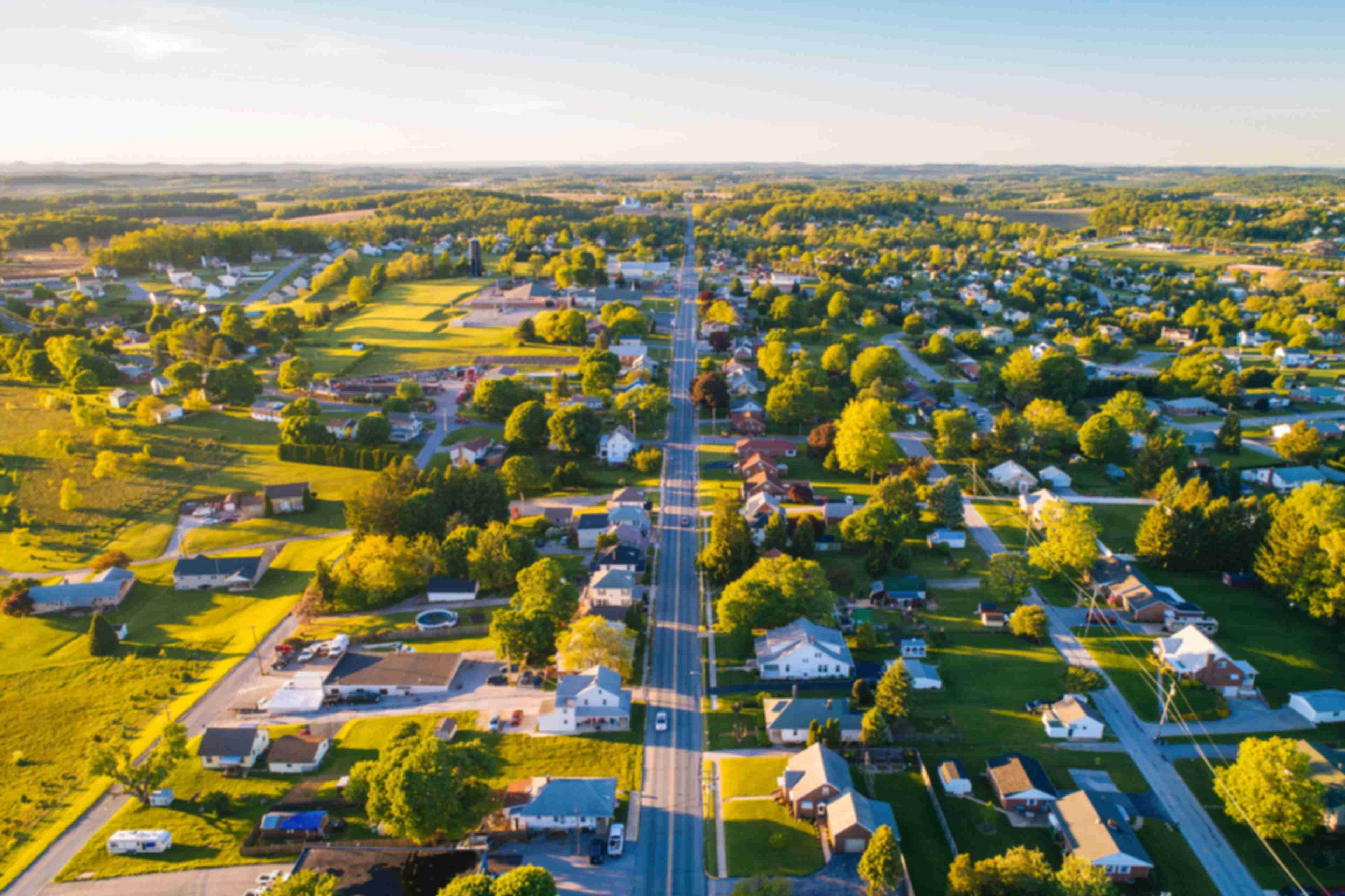Aerial view of Mooresville Station neighborhood in Tanner Alabama with tree-lined streets homes and green fields