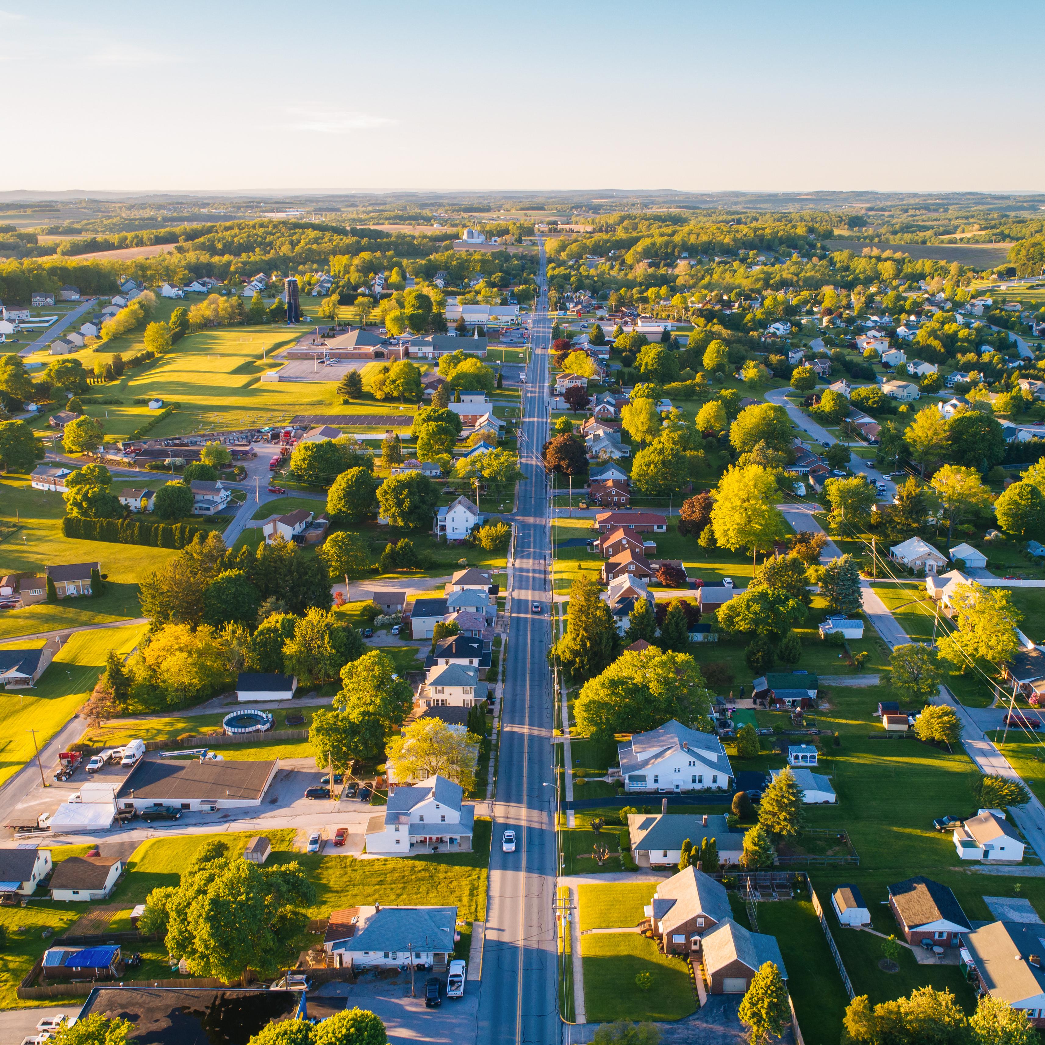 Aerial view of Mooresville Station neighborhood in Tanner Alabama with tree-lined streets homes and green fields