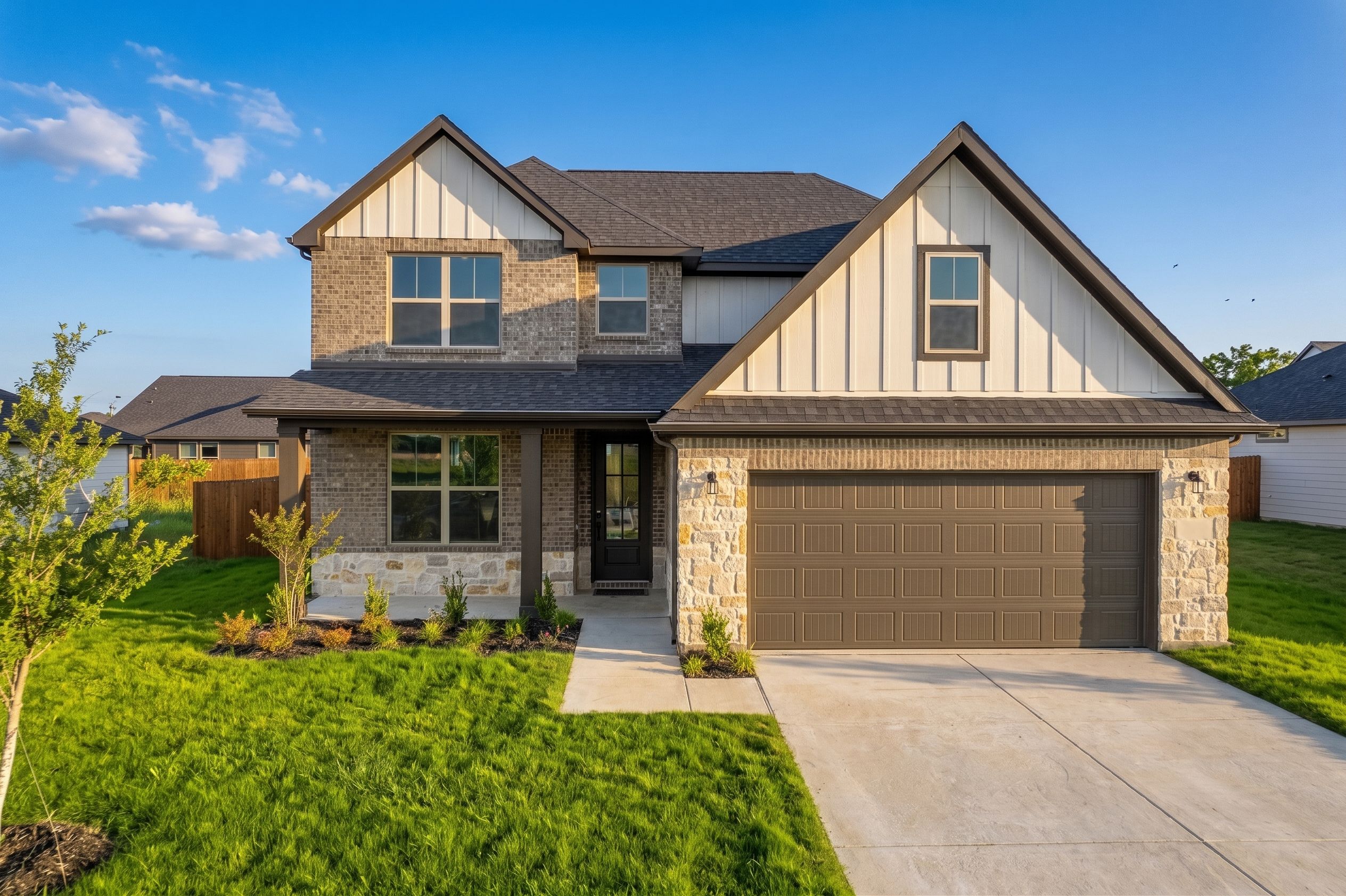 Two-story home with cream brick and stone located n in Josephine, TX