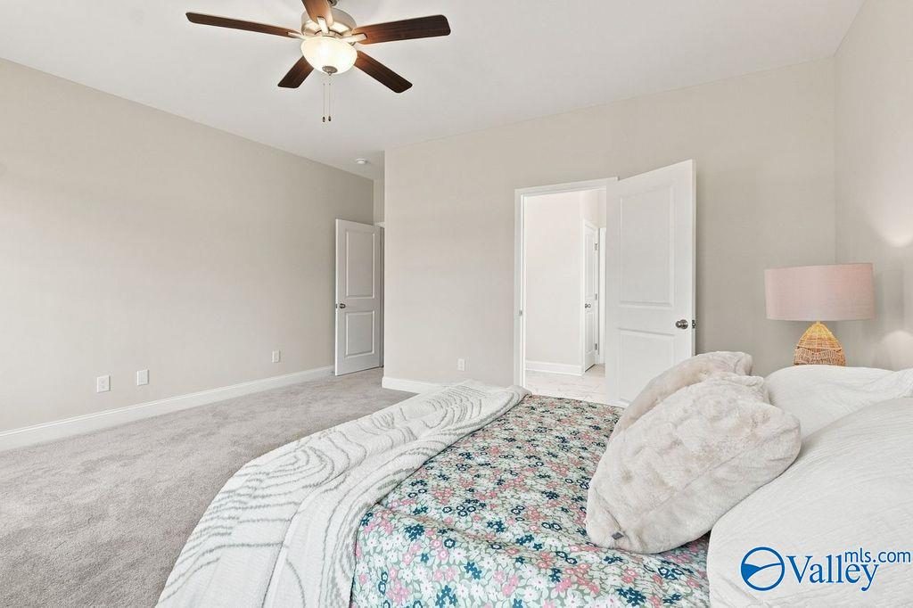 Bright bedroom with ceiling fan and cozy bedding in Davidson Homes' The Harrison floor plan at Cain Park, Hartselle, Alabama
