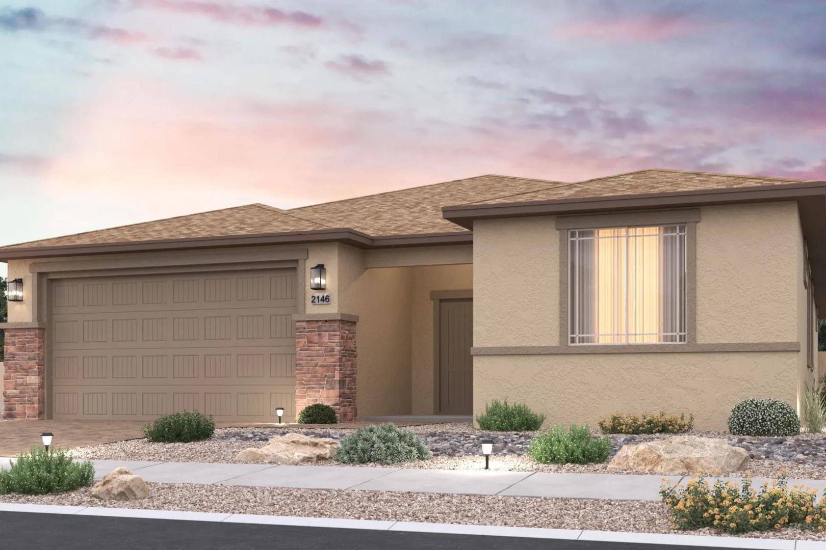 Contemporary tan stucco home at North Ridge Pronghorn Ranch in Prescott Valley AZ with attached garage, desert landscaping, and sunset sky