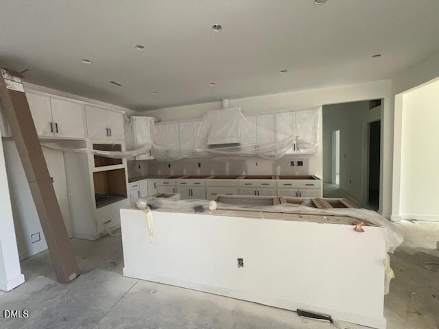 Kitchen under construction with white cabinetry and large center island in Davidson Homes Magnolia II B plan, Lillington NC
