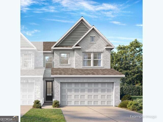 Two-story brick exterior with 2-car garage and landscaped yard at The Cary A by Davidson Homes in Lake Shore, Winder, Georgia