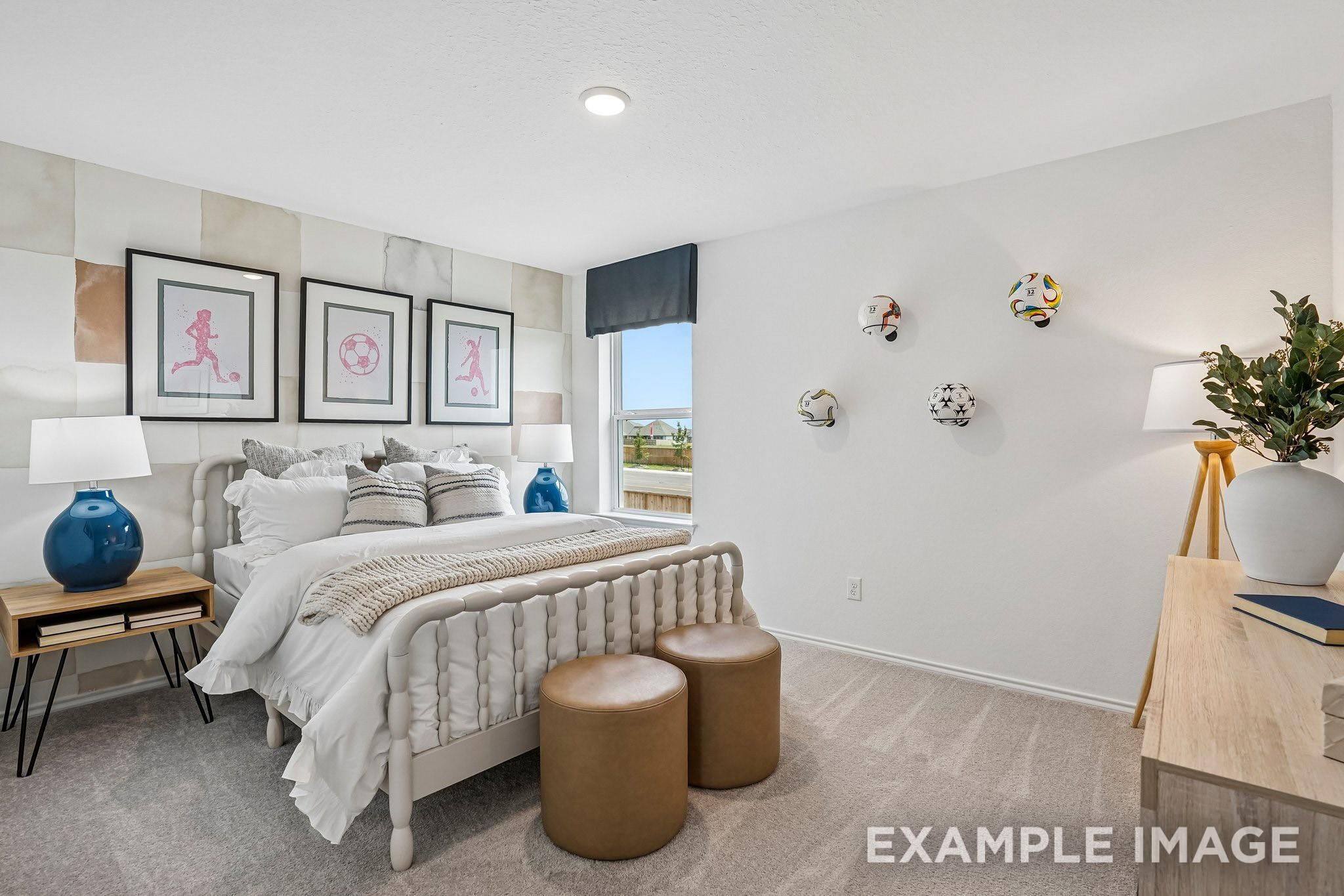 Bright soccer-themed bedroom with white bedding and blue accent lamps in Davidson Homes' The Ashport J, Sundance Cove, Crosby, TX