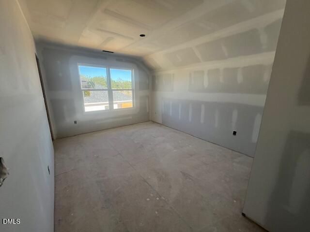 Unfinished bedroom with vaulted ceiling and window in Davidson Homes The Ash C, Retreat at North Main, Lillington, North Carolina