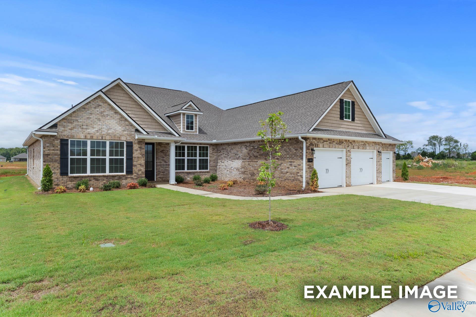 Two-story brick home with 3-car garage, shingled roof, and landscaped yard in Kendall Farms, Toney, Alabama