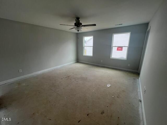 Spacious empty bedroom with ceiling fan, gray walls, and double windows in Davidson Homes The Adalynn B, Lillington, NC