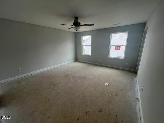 Spacious empty bedroom with ceiling fan, gray walls, and double windows in Davidson Homes The Adalynn B, Lillington, NC