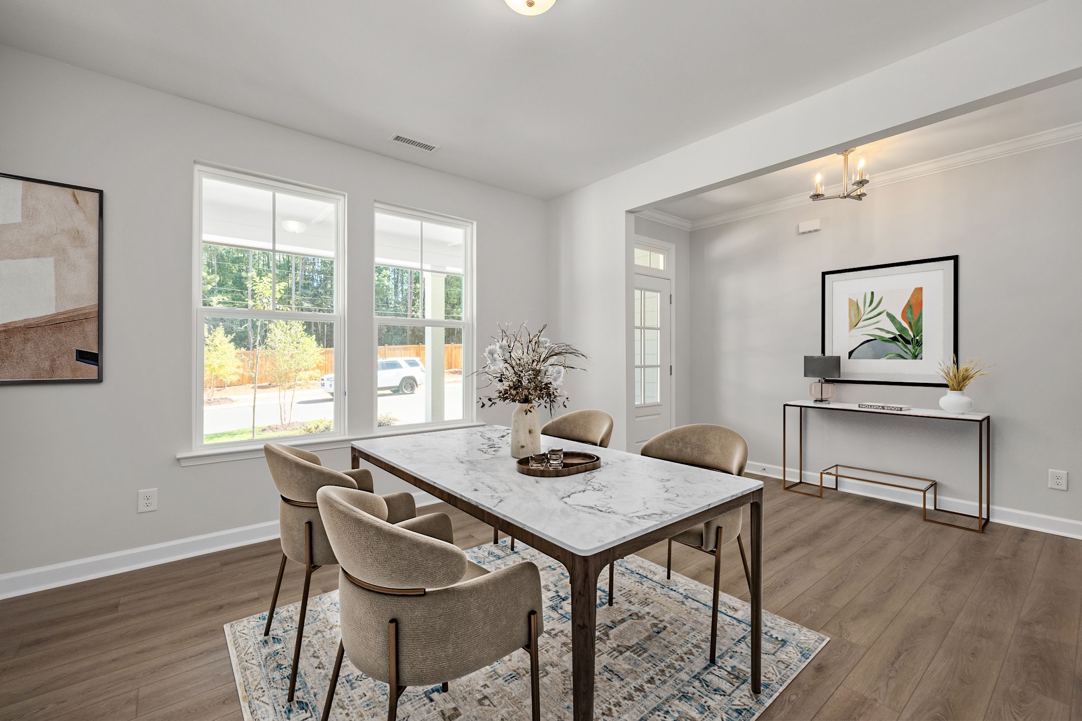 Spacious dining room in Ashland, Apex NC with marble-top table, upholstered chairs, hardwood floors and large windows