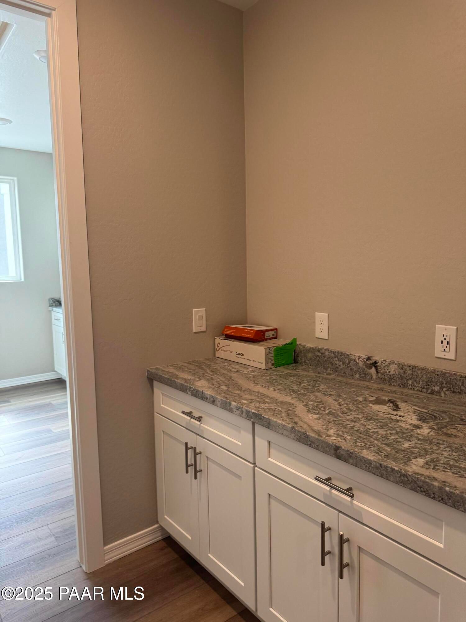 White shaker cabinets and granite countertops in utility area of Davidson Homes The Monarch A, Prescott, Arizona