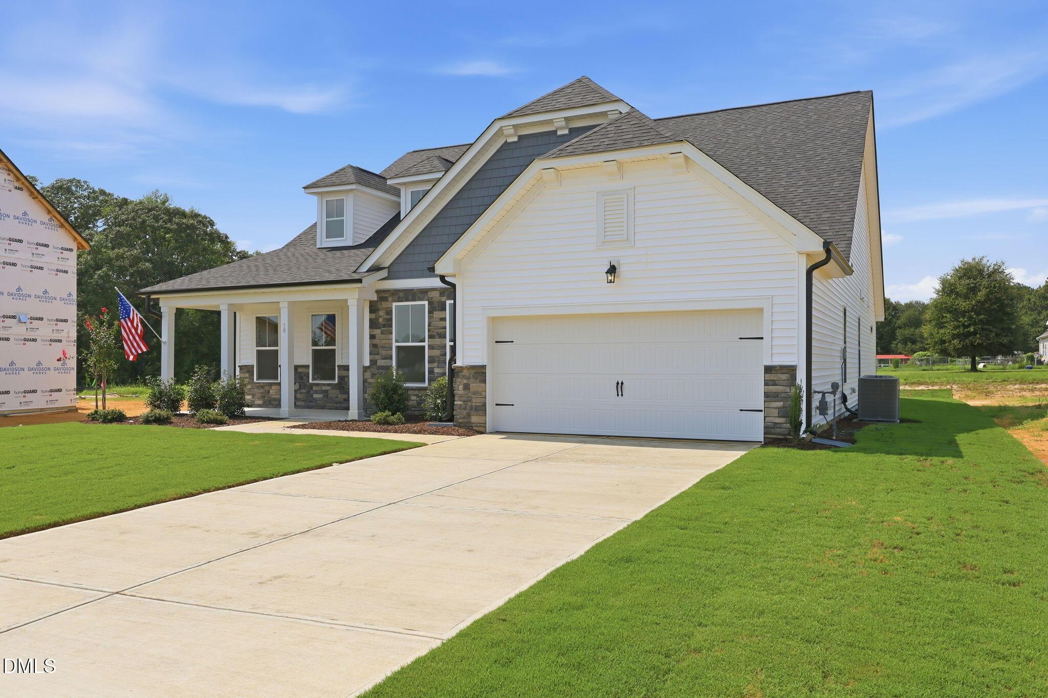 Exterior of The Magnolia B floor plan by Davidson Homes with 2-car garage in Retreat at North Main, Lillington, NC.