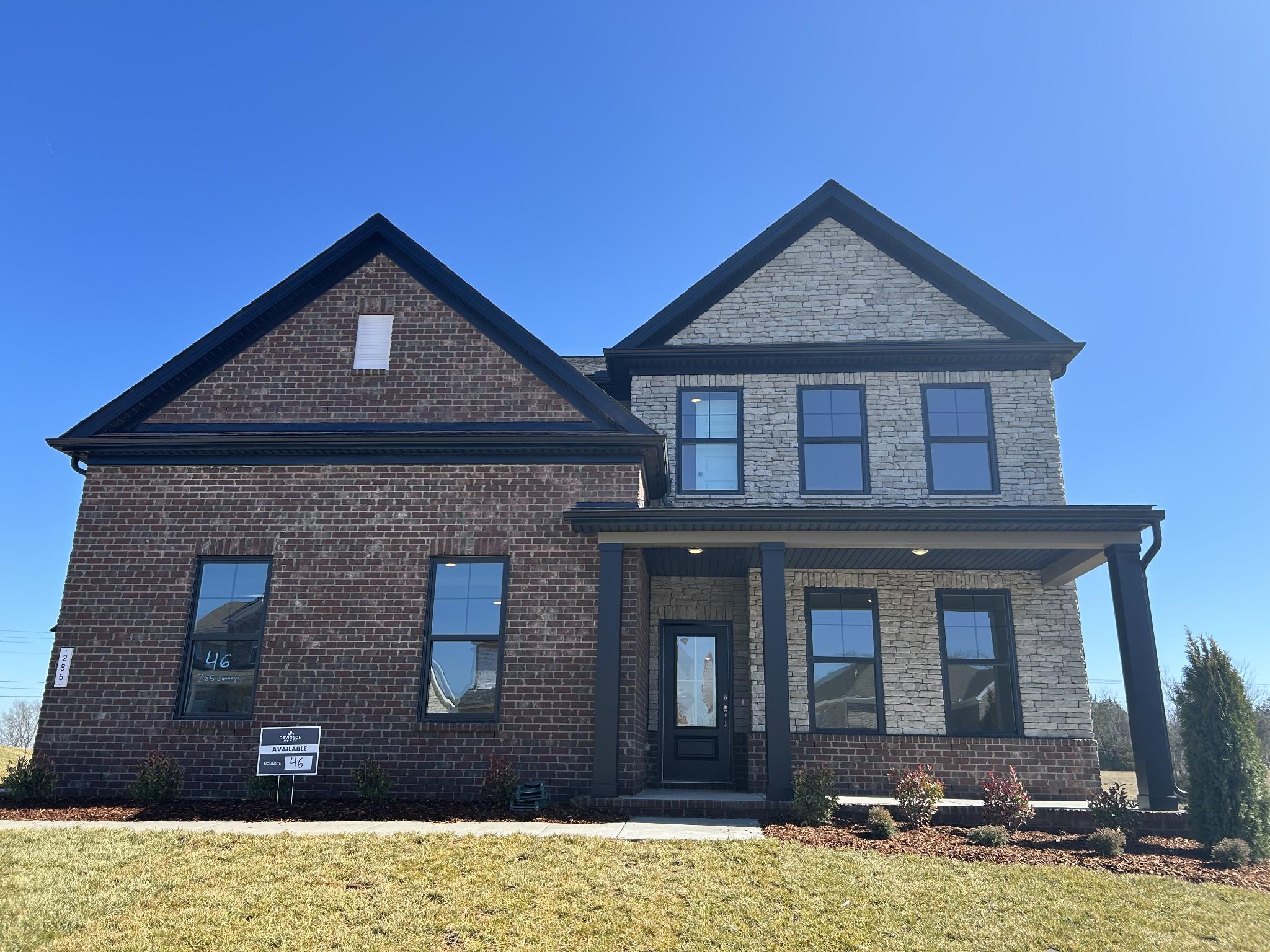 Modern two-story brick home with black trim, covered porch, and landscaped front yard in Benders Cove, Mt. Juliet, Tennessee