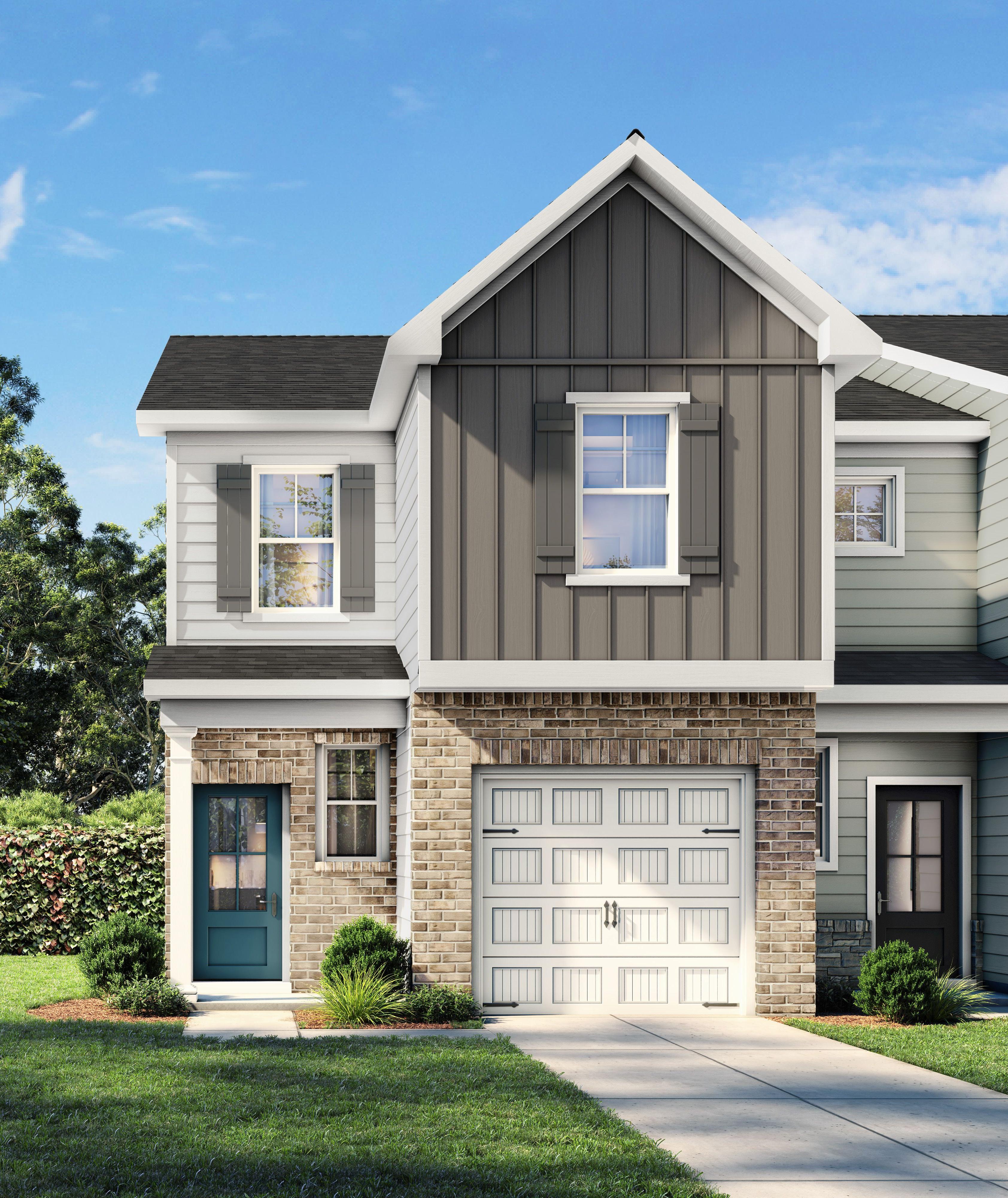 Modern farmhouse townhome exterior at Townes at North Main in Lillington, NC by Davidson Homes with a brick and siding facade.
