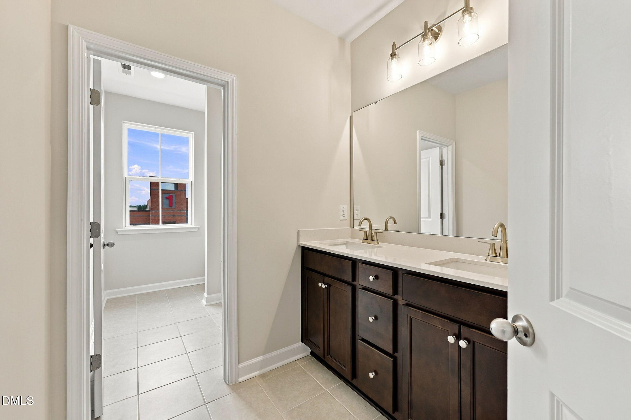 Dual vanity bathroom with dark wood cabinets, quartz countertop, and brushed nickel fixtures in Davidson Homes' The Alexander B, Knightdale NC