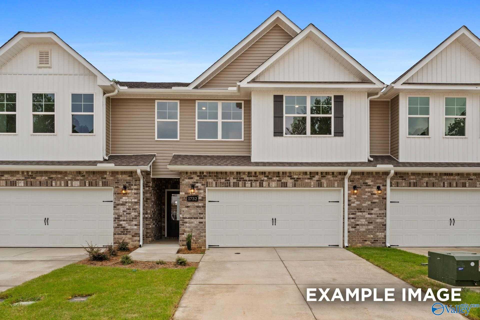 Modern 2-story Davidson Homes The Camden D townhome exterior with 2-car garage and brick accents in Pavilion, Huntsville, Alabama