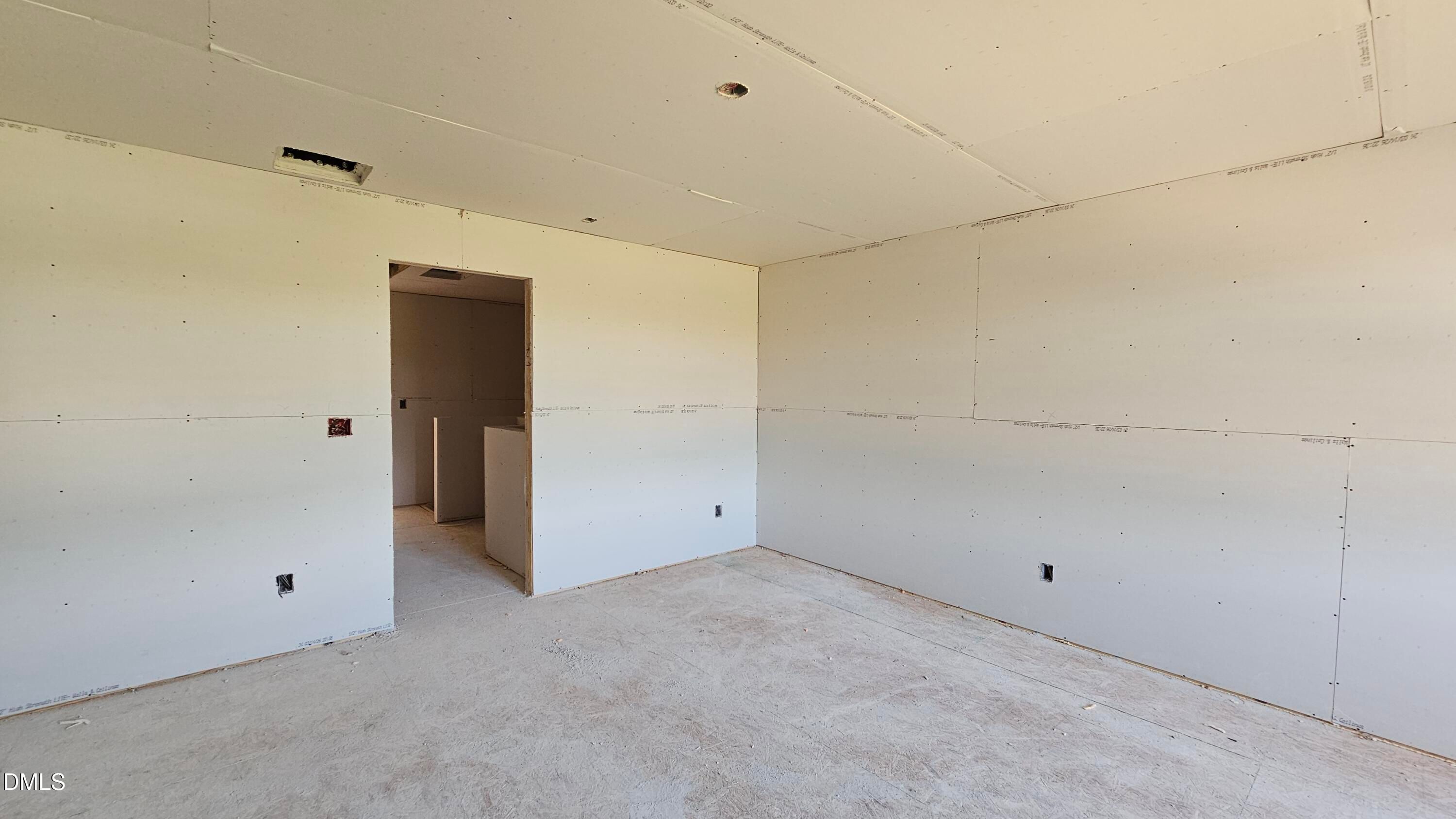 Unfinished bedroom with drywall installation in The Graham Interior floor plan at Springvale, Fuquay-Varina, NC.