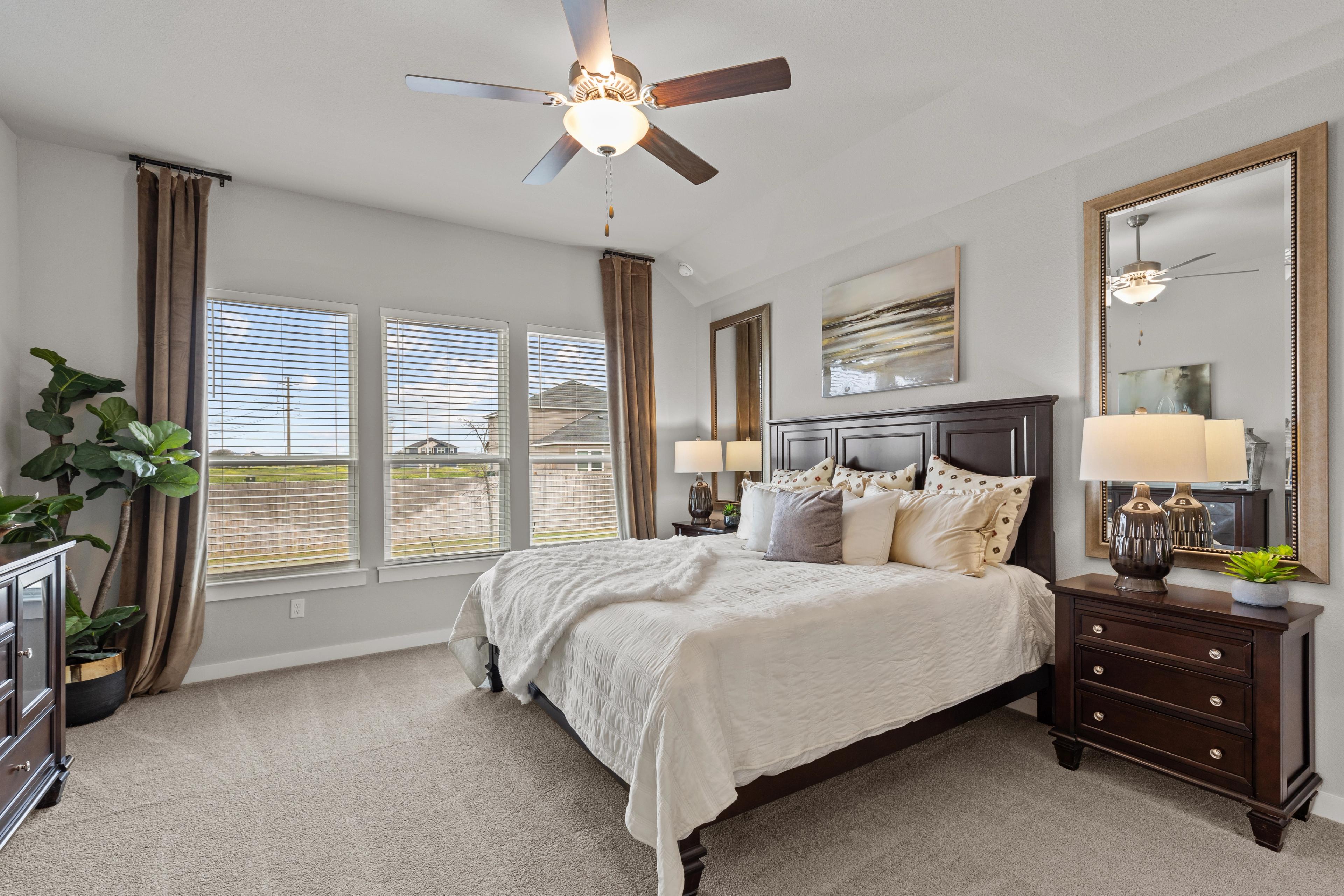 Spacious master bedroom at Hannah Heights in Seguin Texas with king bed, ceiling fan and large windows