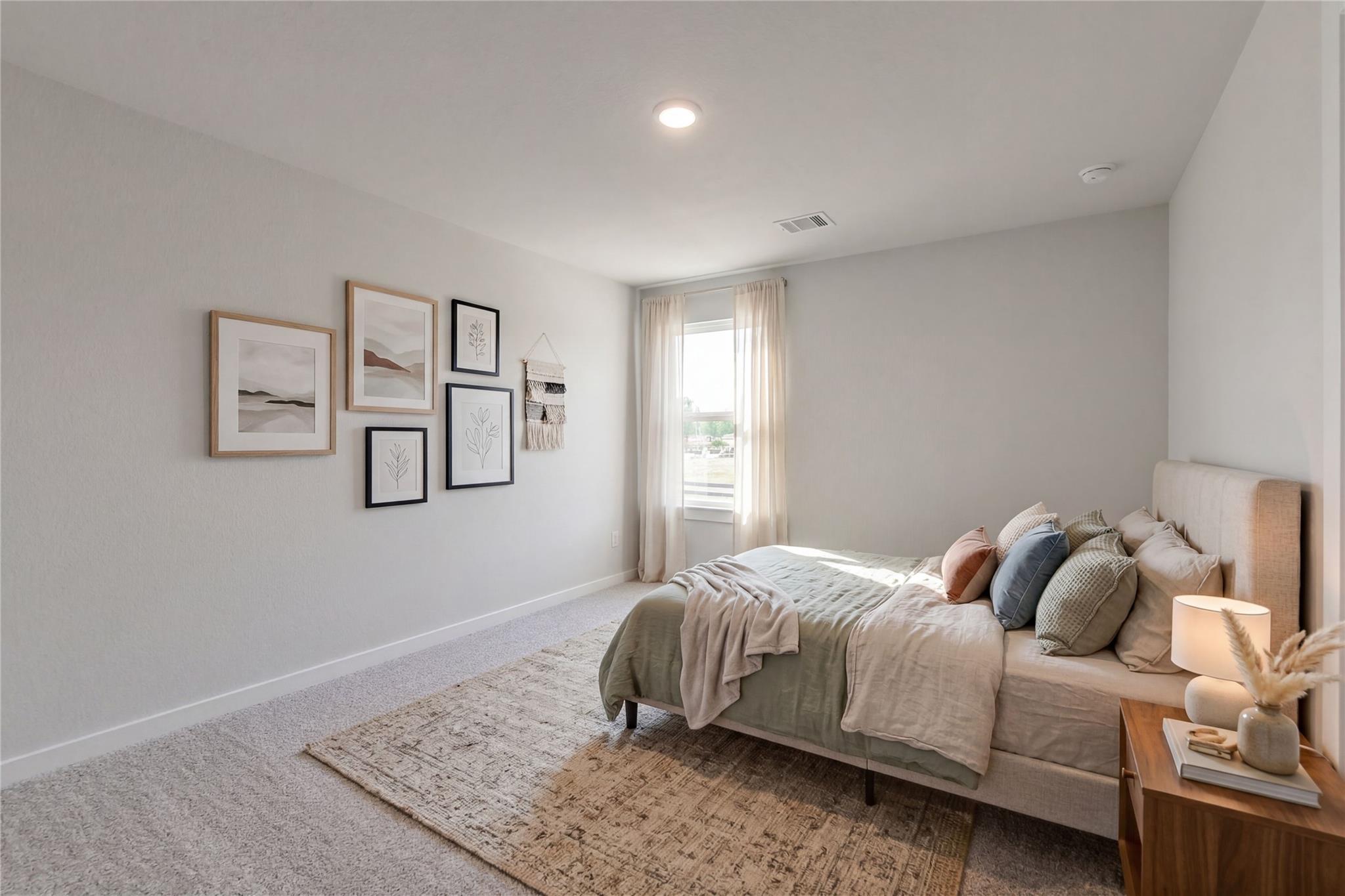 Serene neutral bedroom with upholstered bed, gallery wall art, sheer curtains, and wooden nightstand in Davidson Homes San Marcos E, Conroe TX