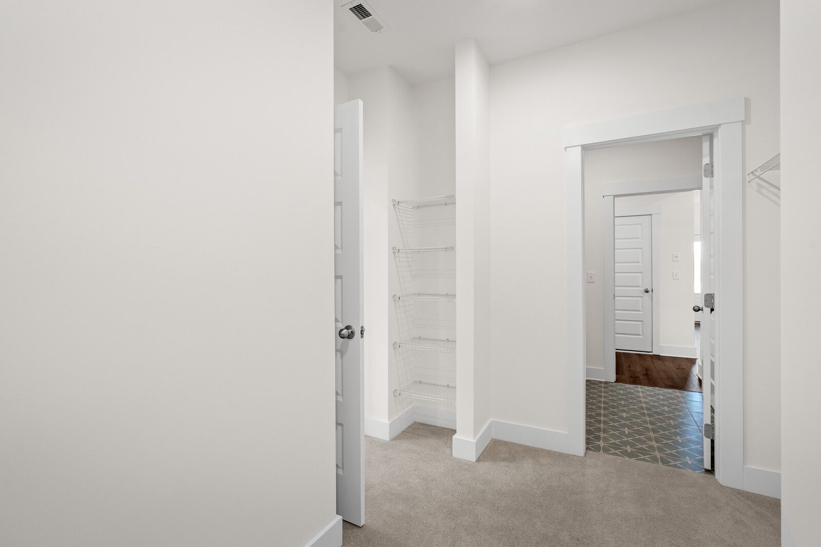 Walk-in closet with wire shelving in The Prairie C floor plan at Woods Crossing, Gallatin, Tennessee.