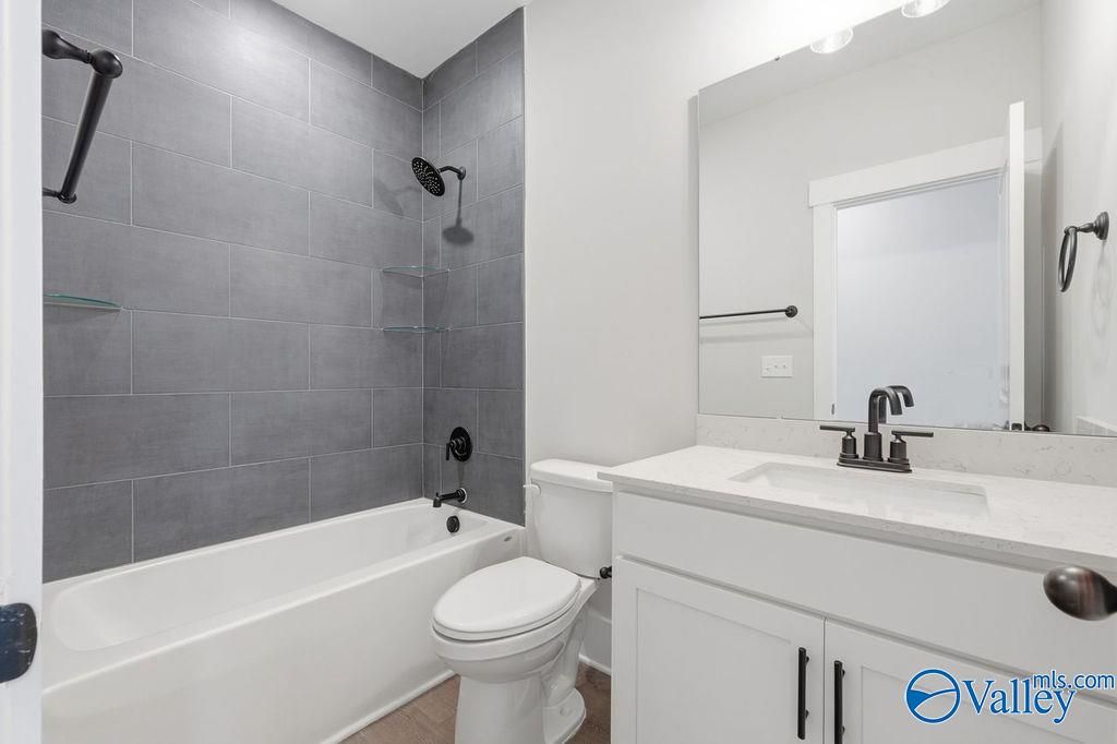 Modern bathroom with gray subway tile shower, freestanding tub, white double vanity in Davidson Homes The Rockford, Hartselle, AL