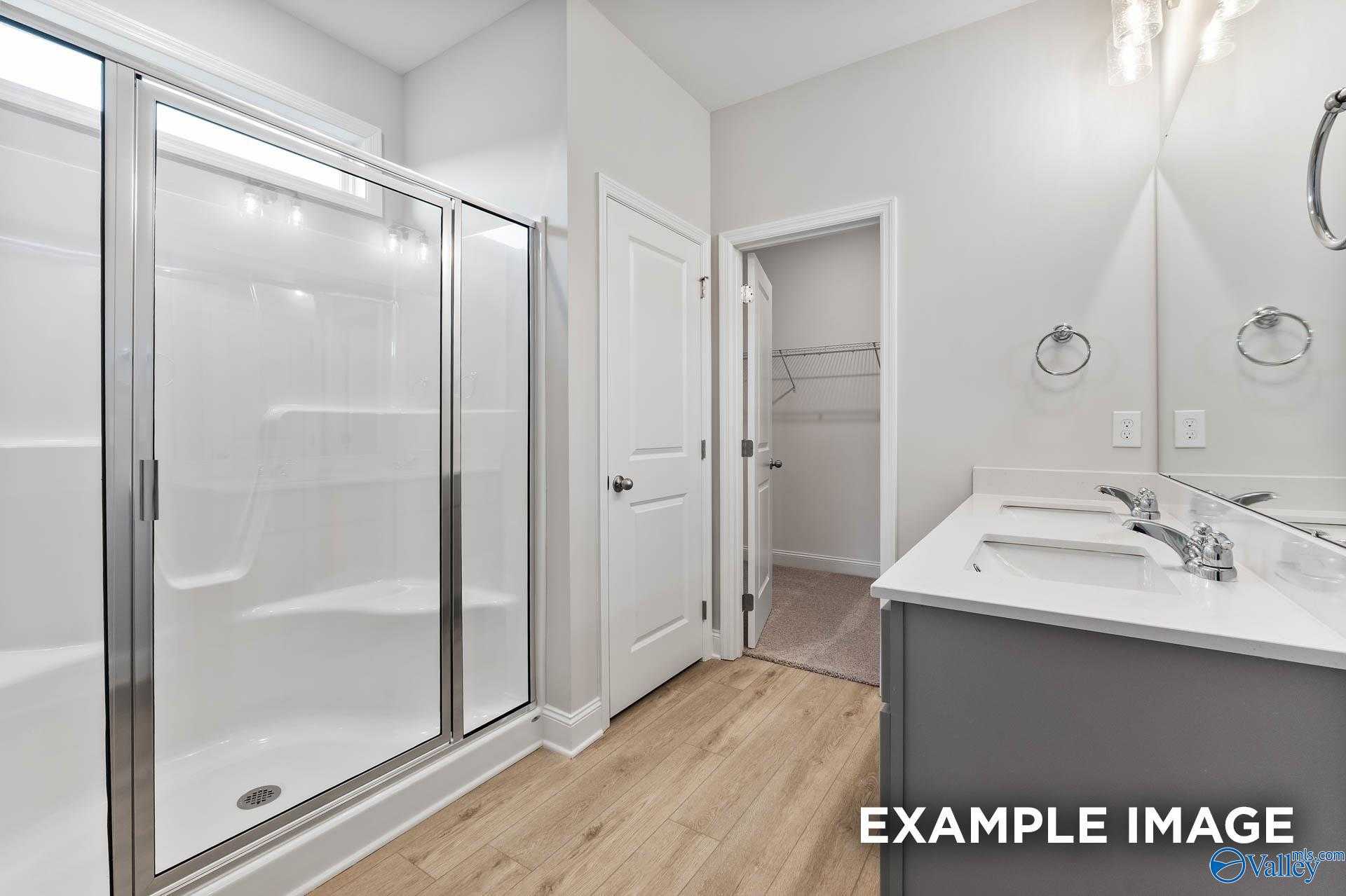 Modern master bathroom featuring glass shower enclosure and double vanity in Davidson Homes The Franklin C, Toney, Alabama