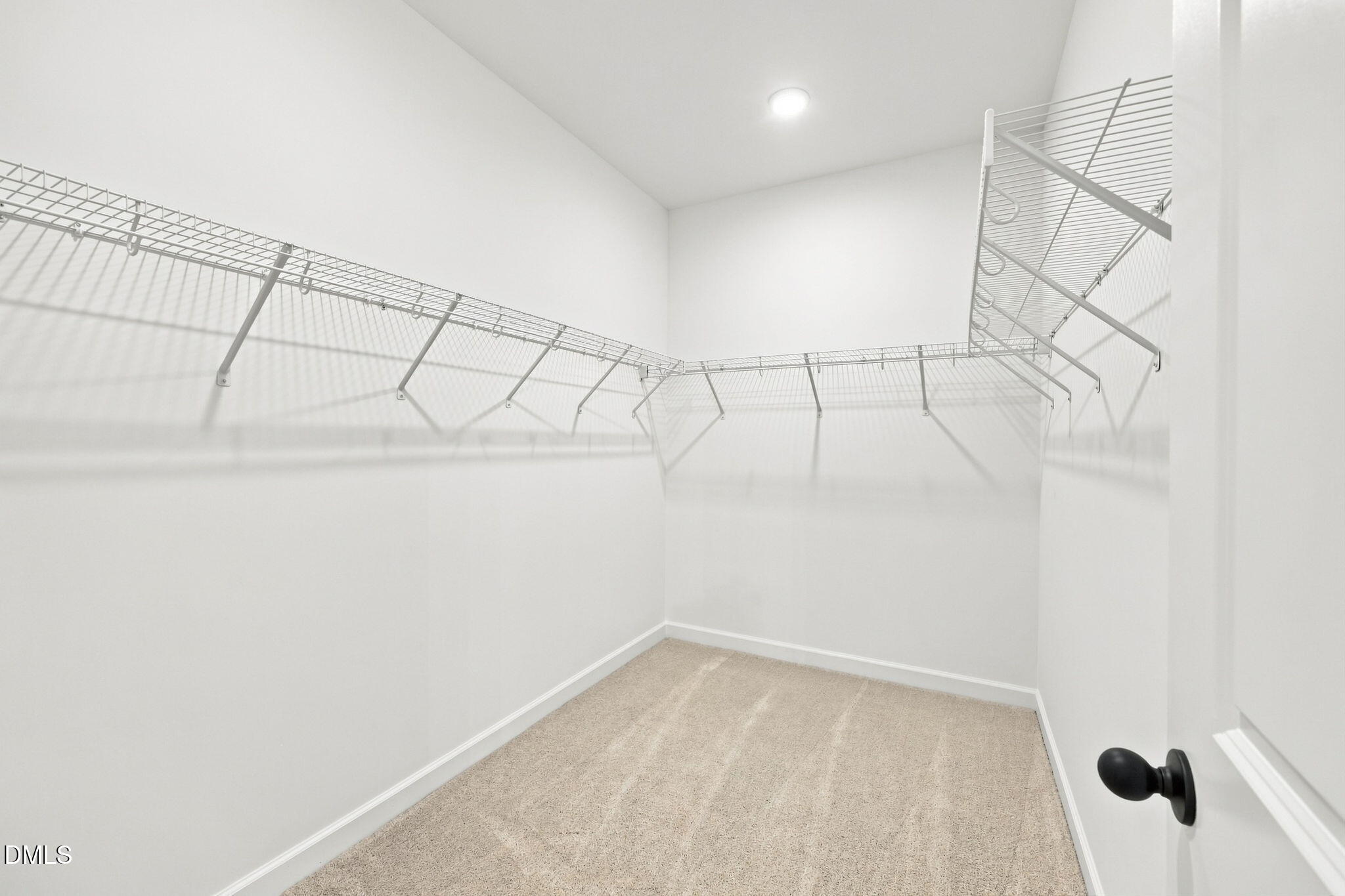 Spacious walk-in closet with wire shelving in The Harris C floor plan at Forestville Yard, Knightdale, North Carolina.