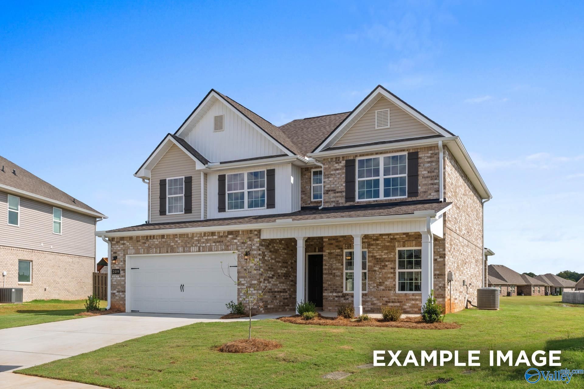 Two-story 4-bedroom Davidson Homes Shelby B with brick facade, 2-car garage, and front porch in Heritage Lakes, New Market, Alabama