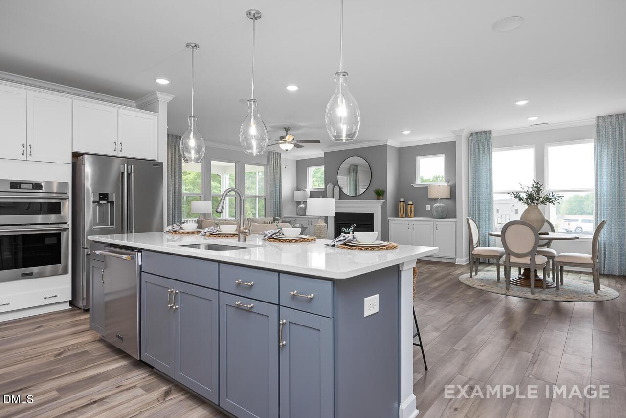 Modern open-concept kitchen and dining area in The Magnolia II B floor plan by Davidson Homes in Ashland, Apex, NC.