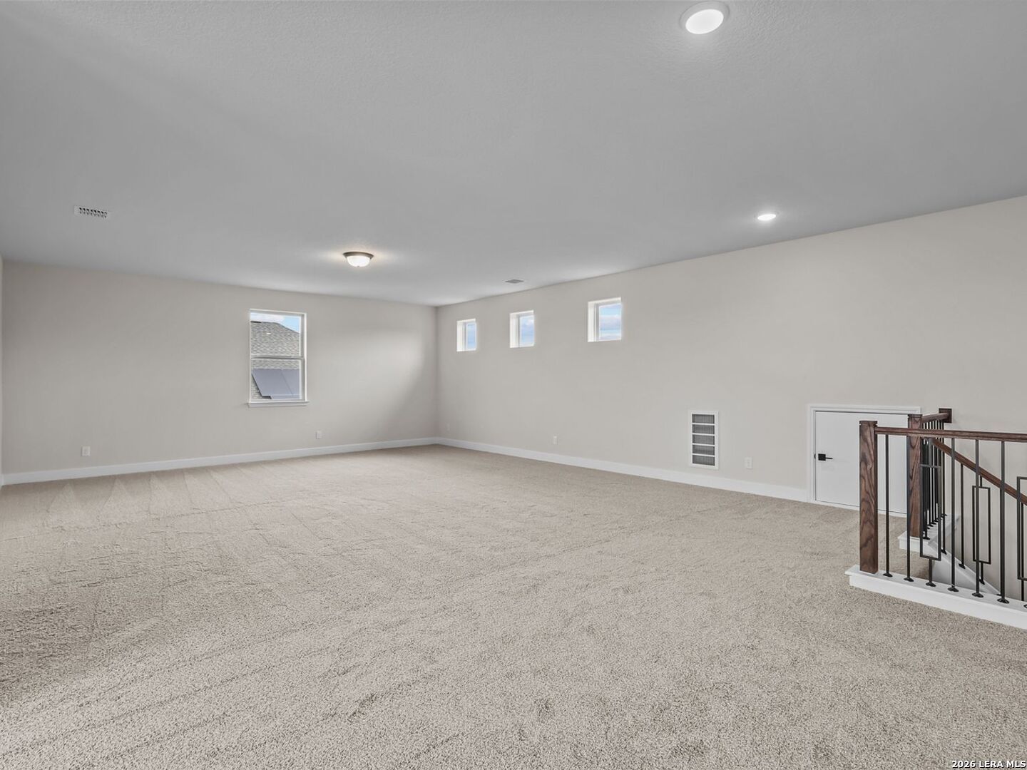 Spacious carpeted game room in The Belmont H floor plan by Davidson Homes in Potranco Oaks, Castroville, Texas.