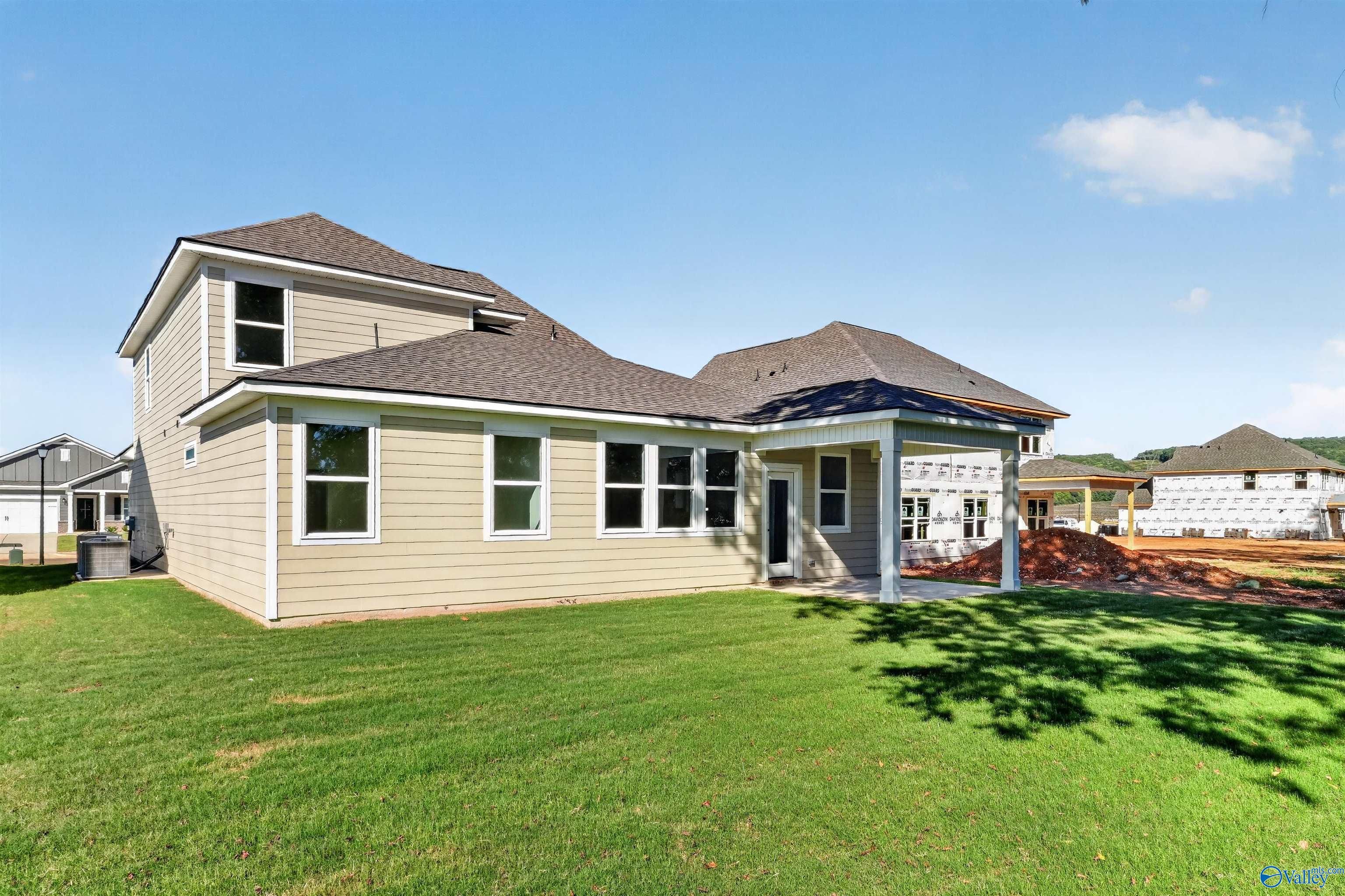 Rear exterior of Davidson Homes' Ashport L 2-story home with covered patio and large backyard in Berry Cove, New Market, Alabama