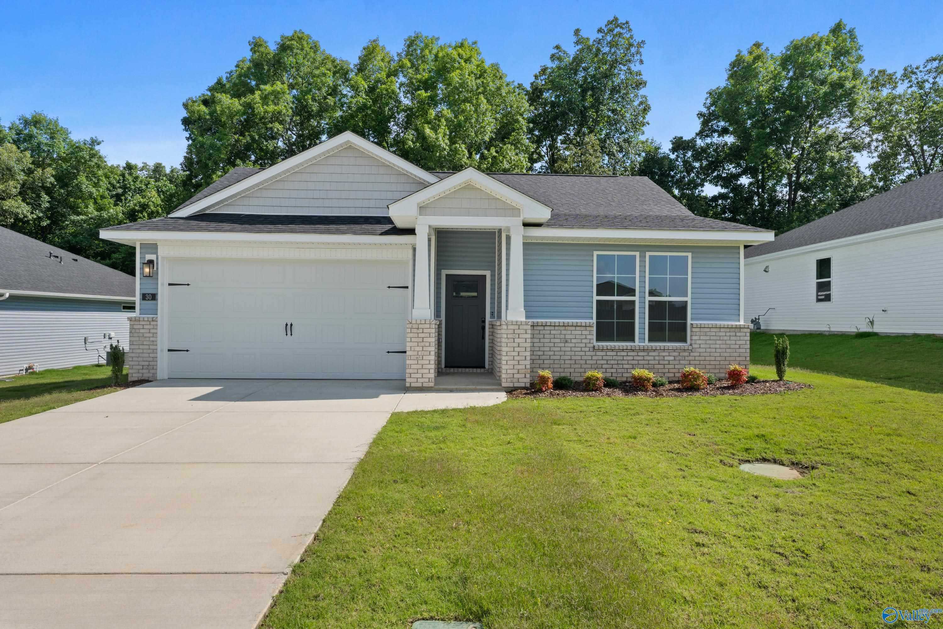Modern single-story 3-bedroom home with blue siding, 2-car garage, brick accents, and landscaped yard in Bailey Park, Fayetteville, Tennessee
