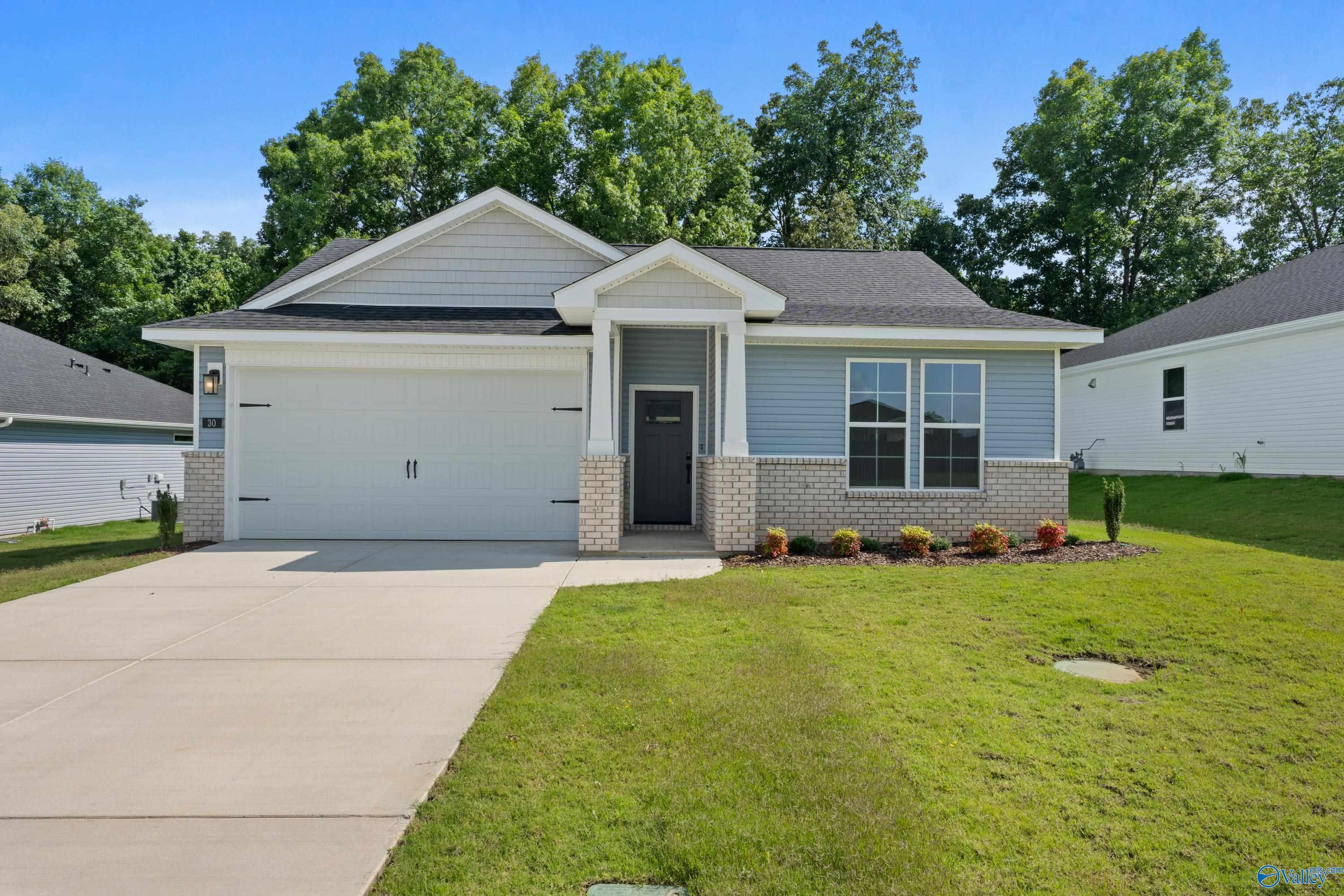 Modern single-story 3-bedroom home with 2-car garage, brick accents, and landscaped yard in Bailey Park, Fayetteville, Tennessee