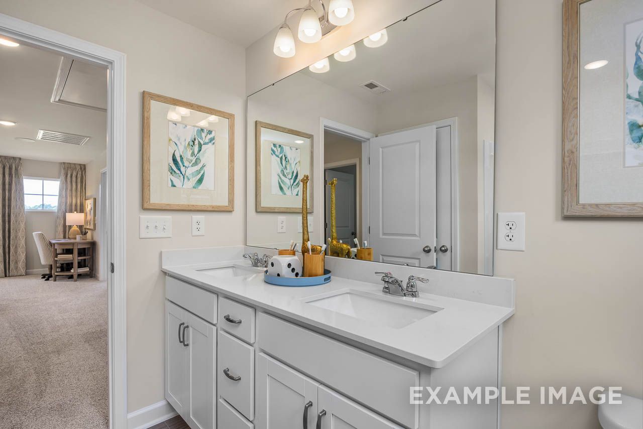 Dual vanity bathroom in The Willow C-BF by Davidson Homes Mt. Juliet, featuring white shaker cabinets and quartz countertop.