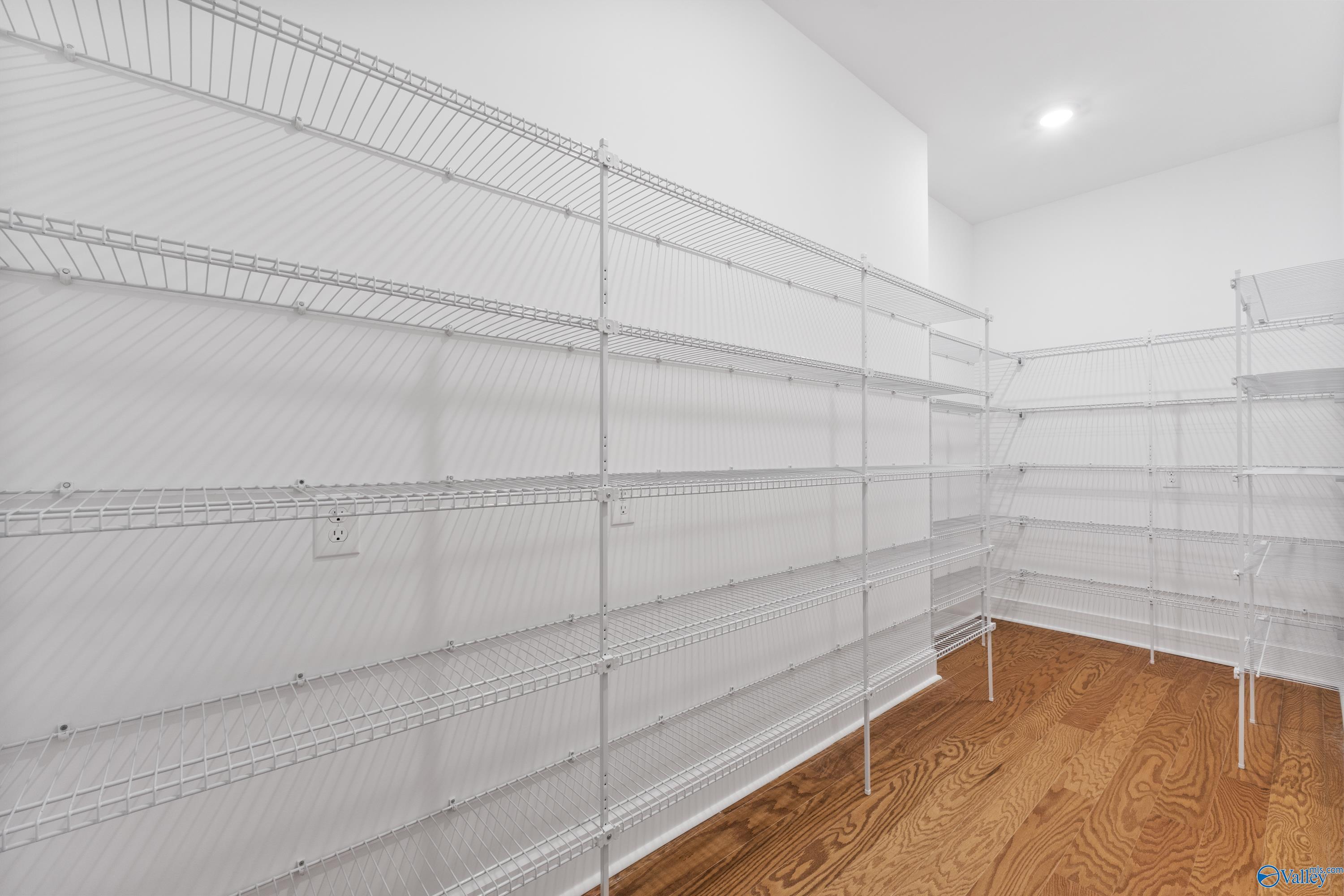 Spacious walk-in closet with white wire shelving and hardwood floors in Davidson Homes The Arcadia, Riverton Preserve, Huntsville