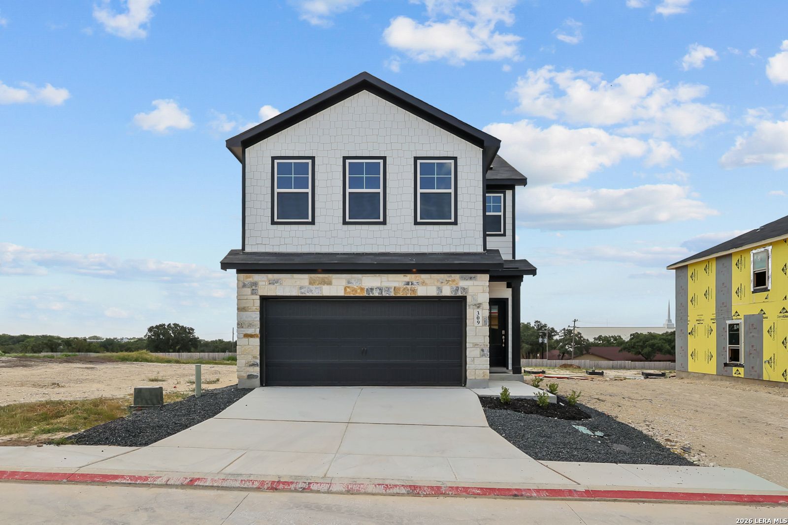 Two-story Gillian B floor plan by Davidson Homes with stone and siding exterior in Meadows at Oak Creek, San Antonio, Texas.