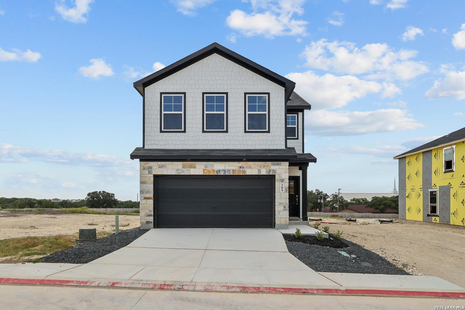 Two-story Gillian B floor plan by Davidson Homes with stone exterior and 2-car garage in Meadows at Oak Creek, San Antonio.