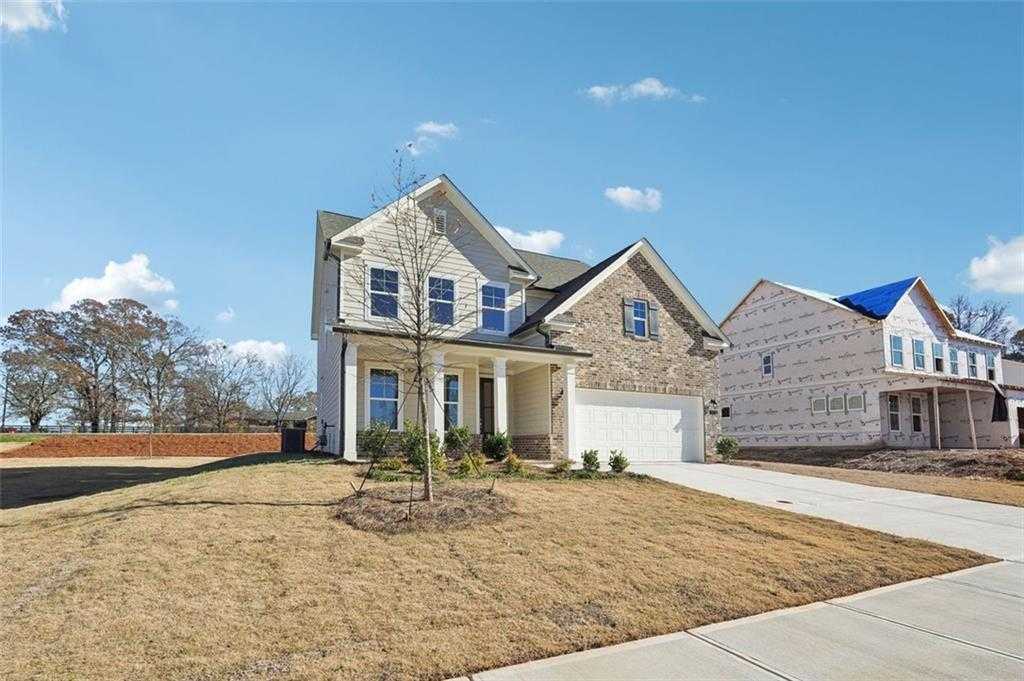 Two-story 4-bedroom Davidson Homes Hickory C with stone accents, covered porch, 2-car garage in Wehunt Meadows, Hoschton GA