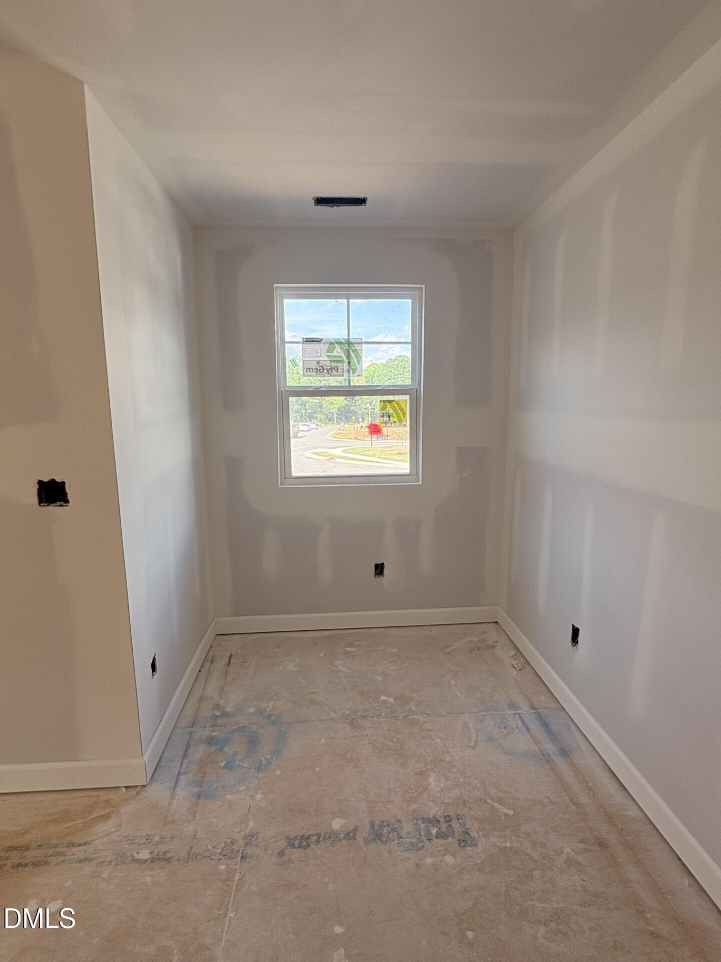 Unfinished bedroom nook with drywall and single window in The Ash C floor plan at Woodland Crossing, Zebulon, NC.