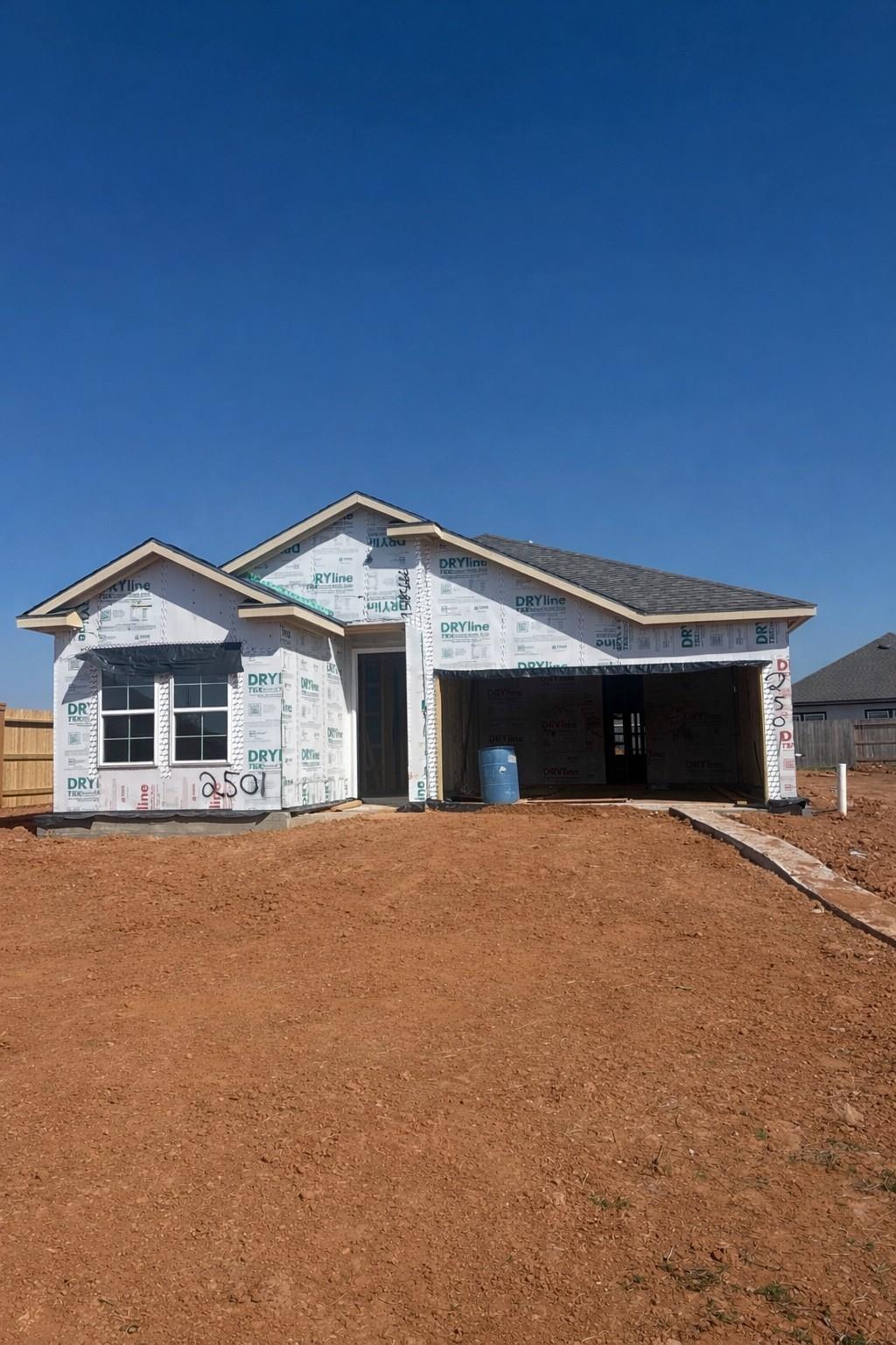 Under-construction single-story Davidson Homes The Laguna C: 3-bed, 2-car garage house with sheathing in Sunterra, Katy, Texas
