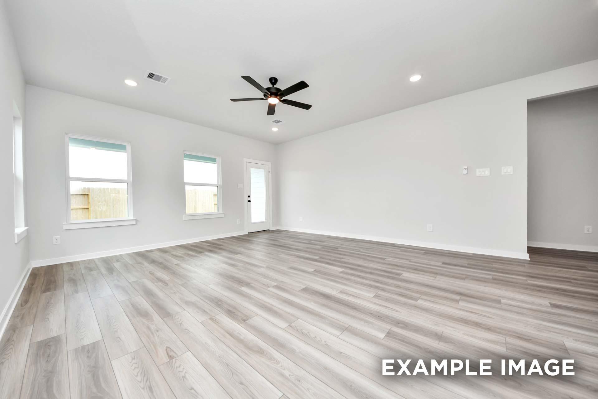 Spacious open-concept living area in The Sorrento featuring modern light wood flooring and recessed lighting.