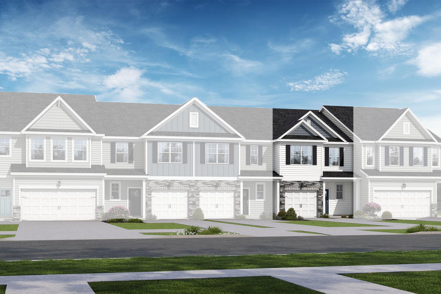 Modern 2-story townhome row in The Graham design by Davidson Homes, featuring white siding, black accents, garages, and lush landscaping in Lillington, NC