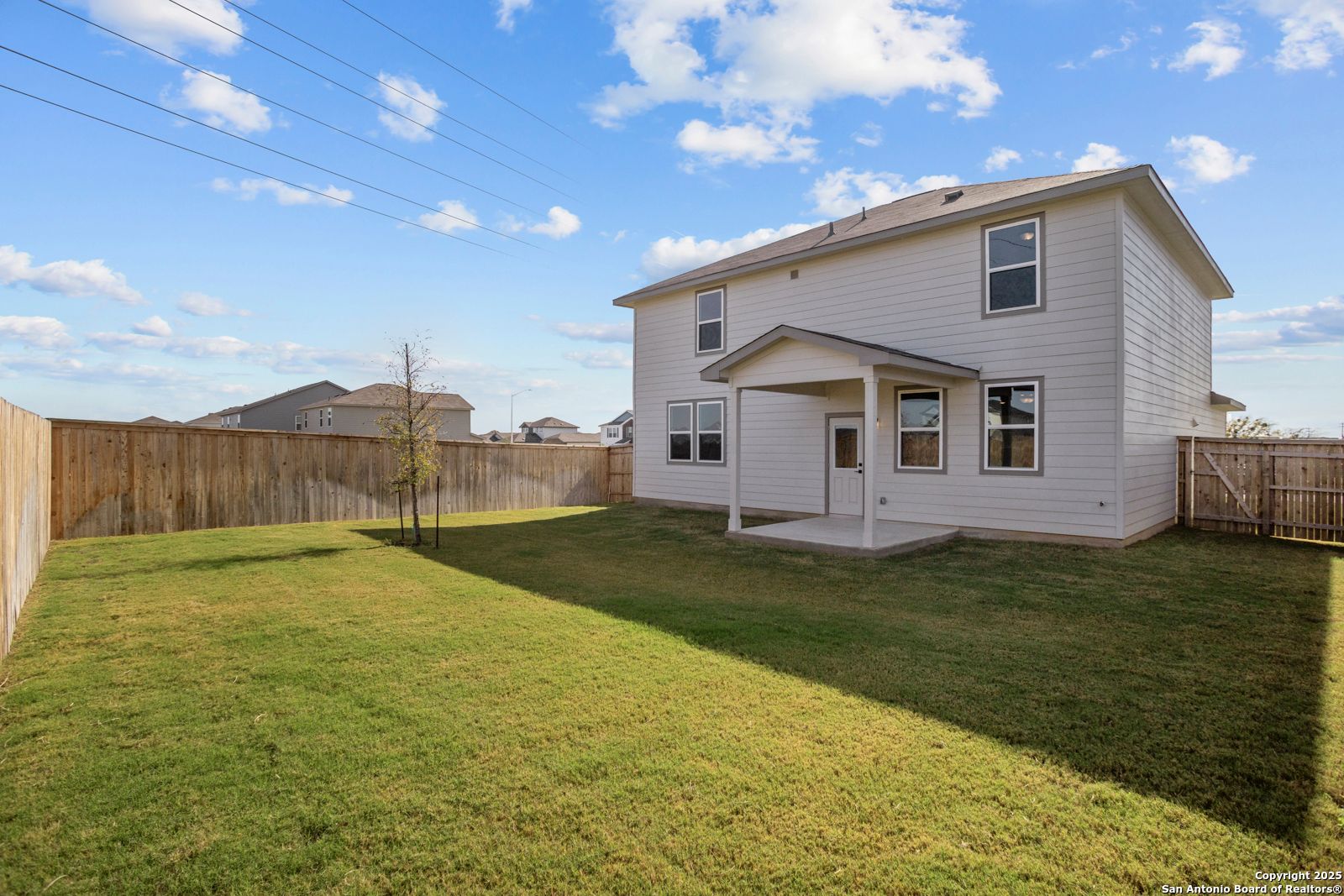 Covered back patio and fenced grassy backyard in 2-story Davidson Homes The Douglas C, Hannah Heights, Seguin, Texas