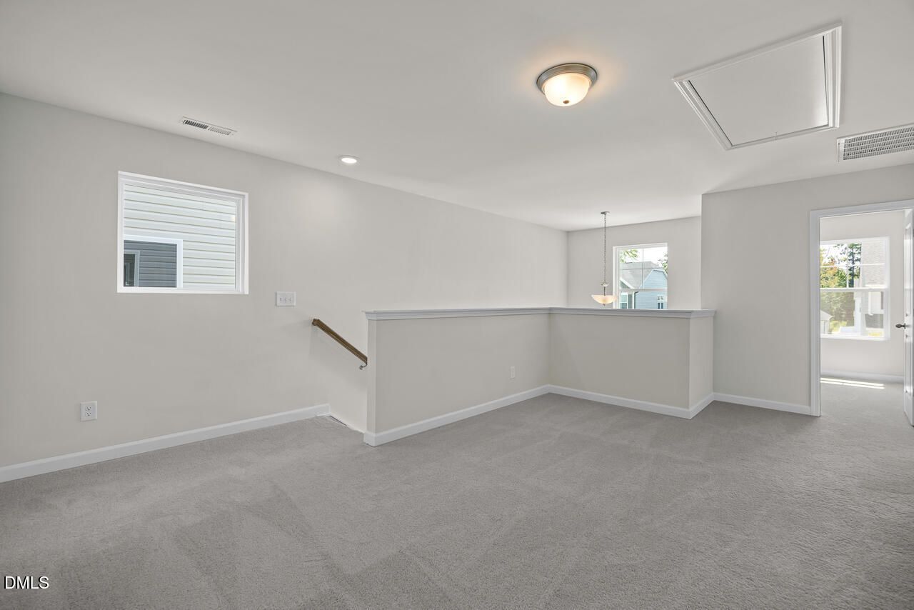 Spacious carpeted loft area in The Gavin A floor plan at Gregory Village in Lillington, North Carolina.