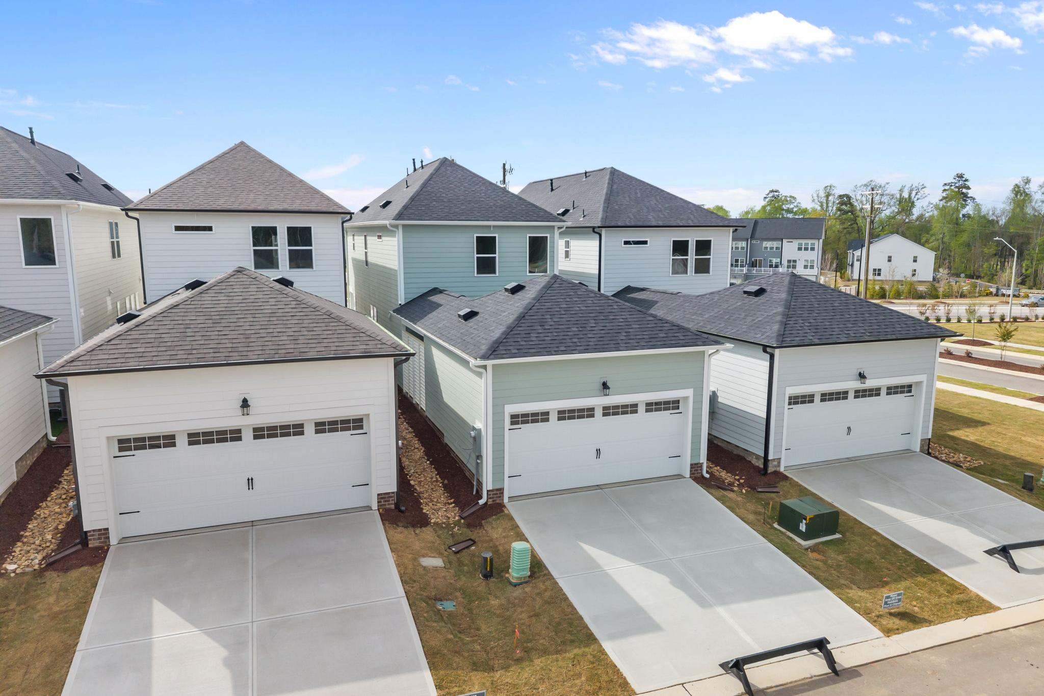Aerial view of modern townhomes at Forestville Yard in Knightdale NC with attached garages, driveways, and landscaped yards