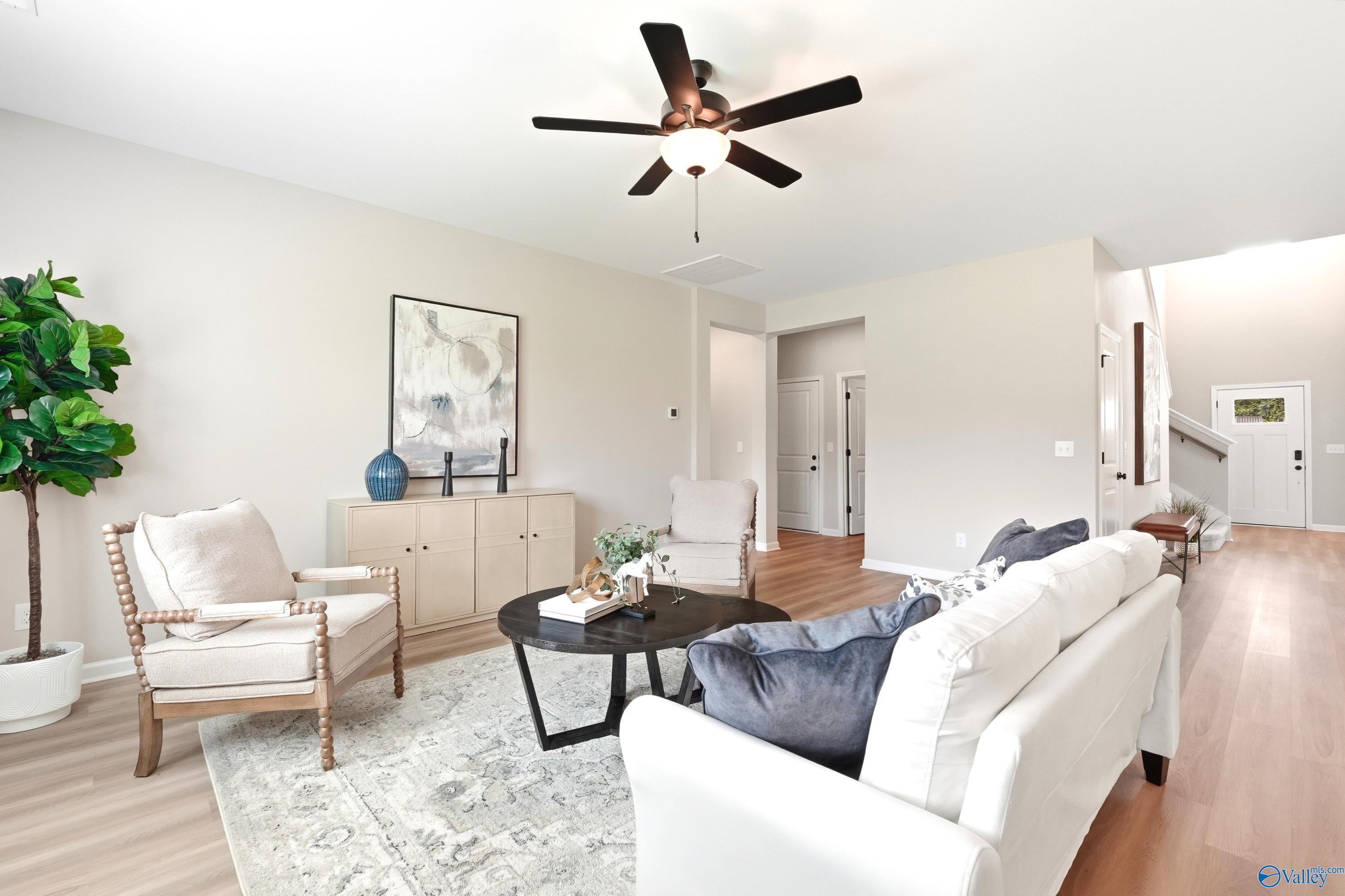 Bright, open living room with neutral decor in The Dorado floor plan by Davidson Homes in Riverton Preserve, Huntsville.