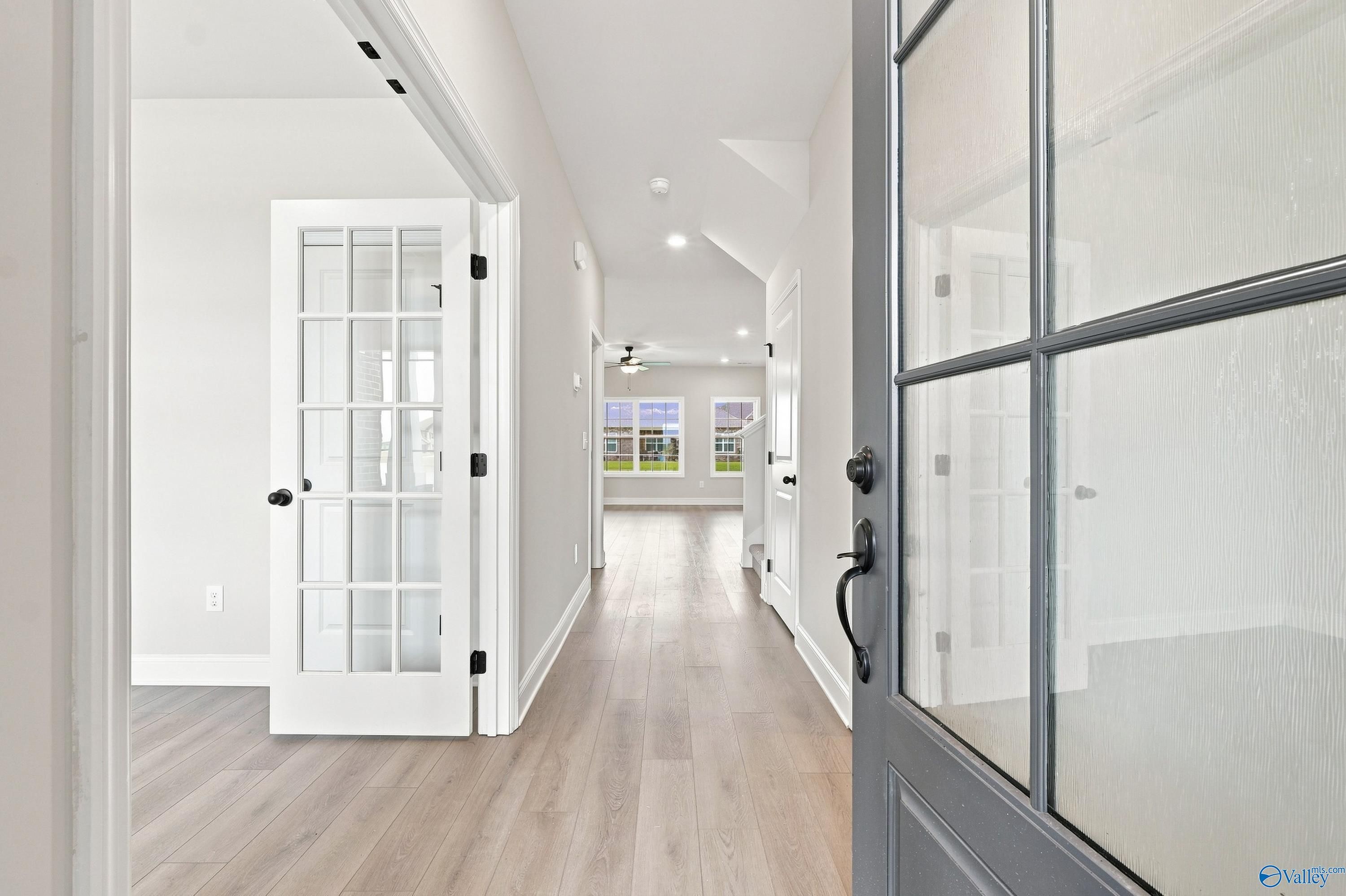 Bright entryway with French doors and wood-look flooring in The Rockford B floor plan at Kendall Downs, Toney, Alabama.