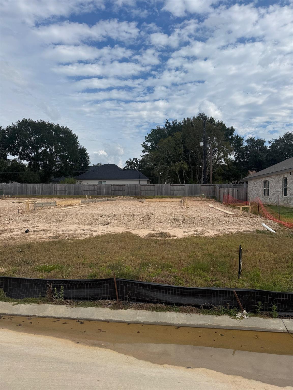 Vacant residential lot prepared for construction of The Sabine E floor plan in Windmill Estates, Magnolia, Texas.